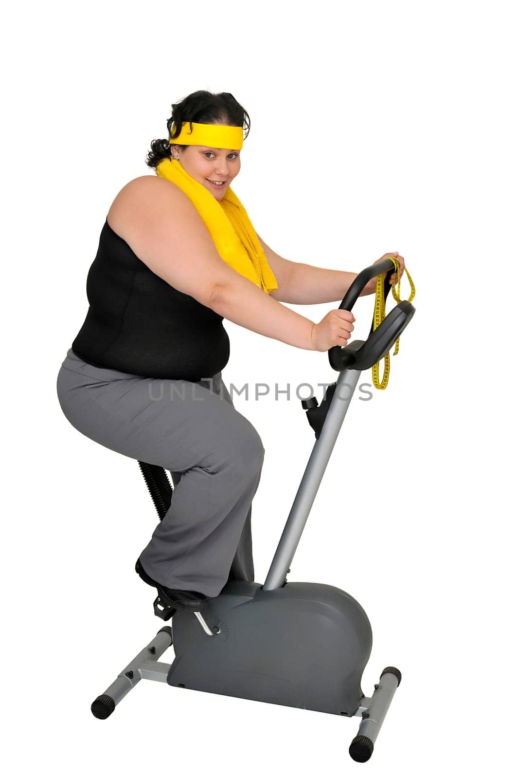 Large girl with fitness bicycle isolated in white