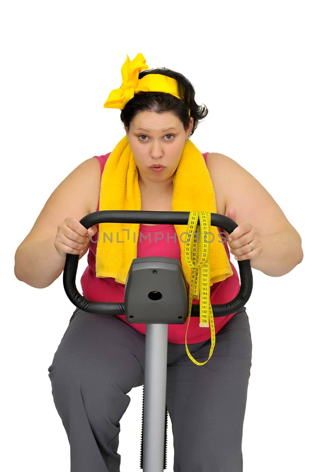 Large girl with fitness bicycle isolated in white