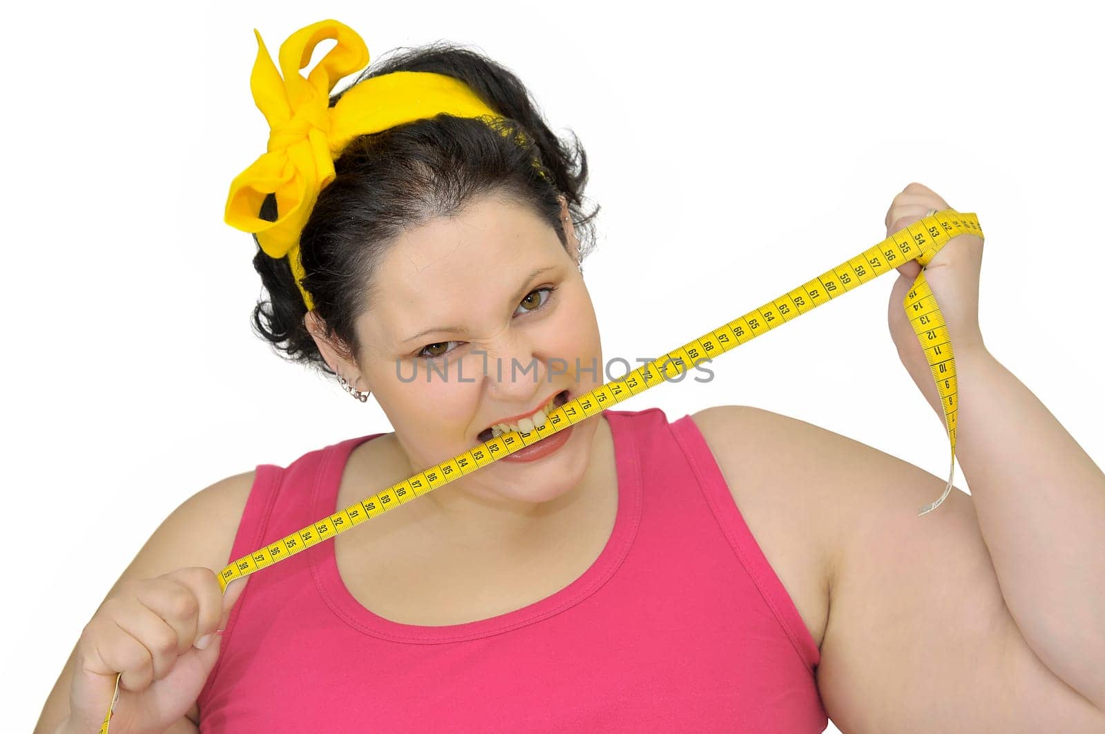 Angry large girl biting measuring tape