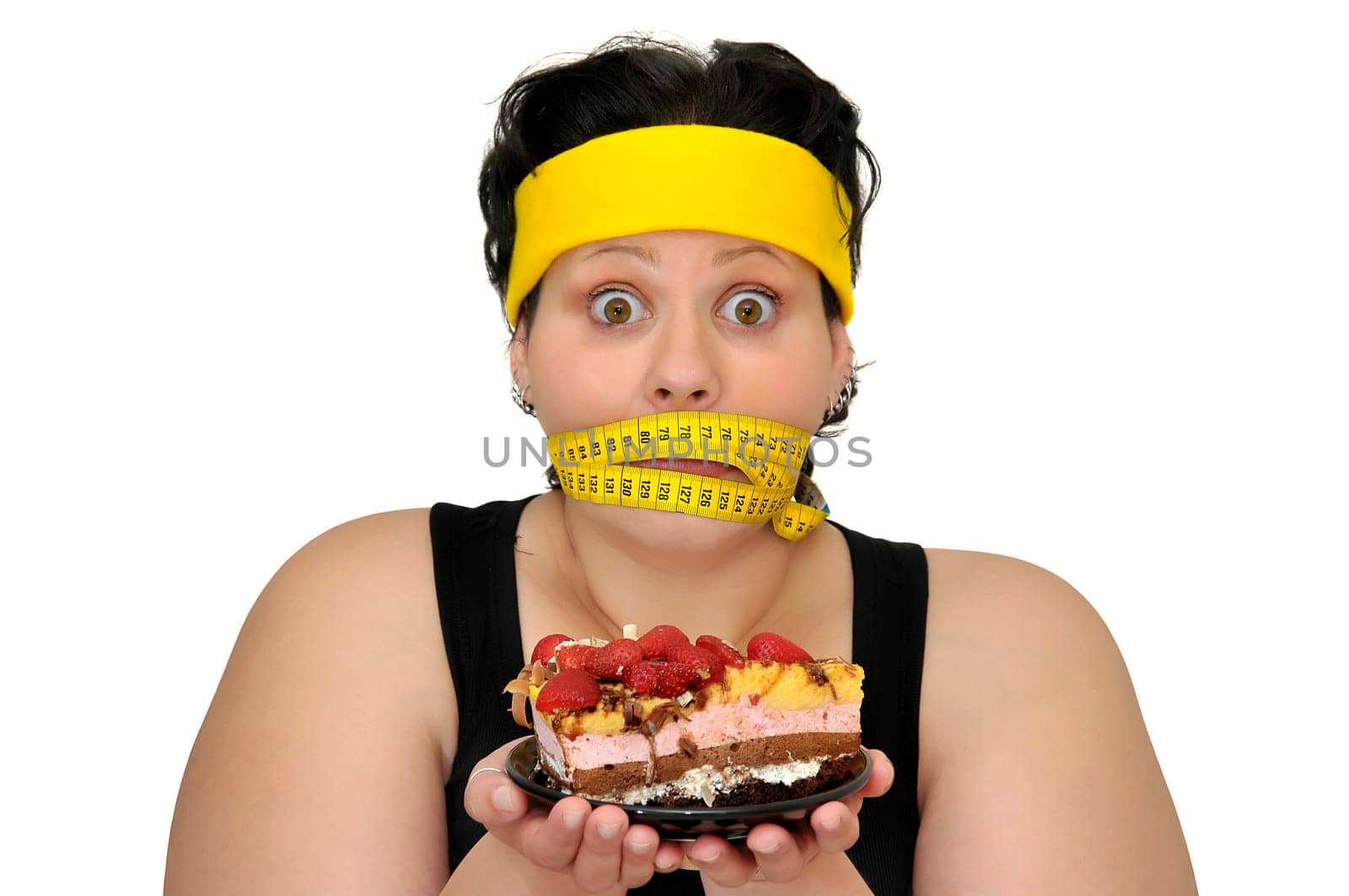 Large girl gaged with measuring tape holding a cake isolated in white