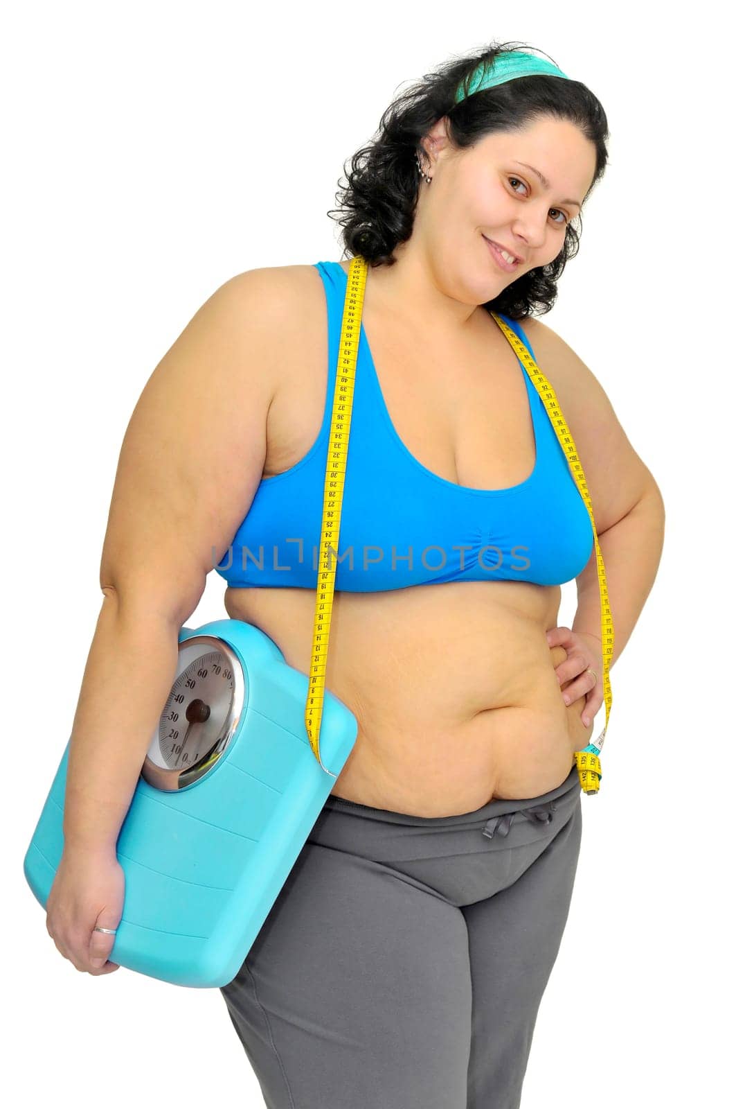 Large girl with weight scale isolated in white