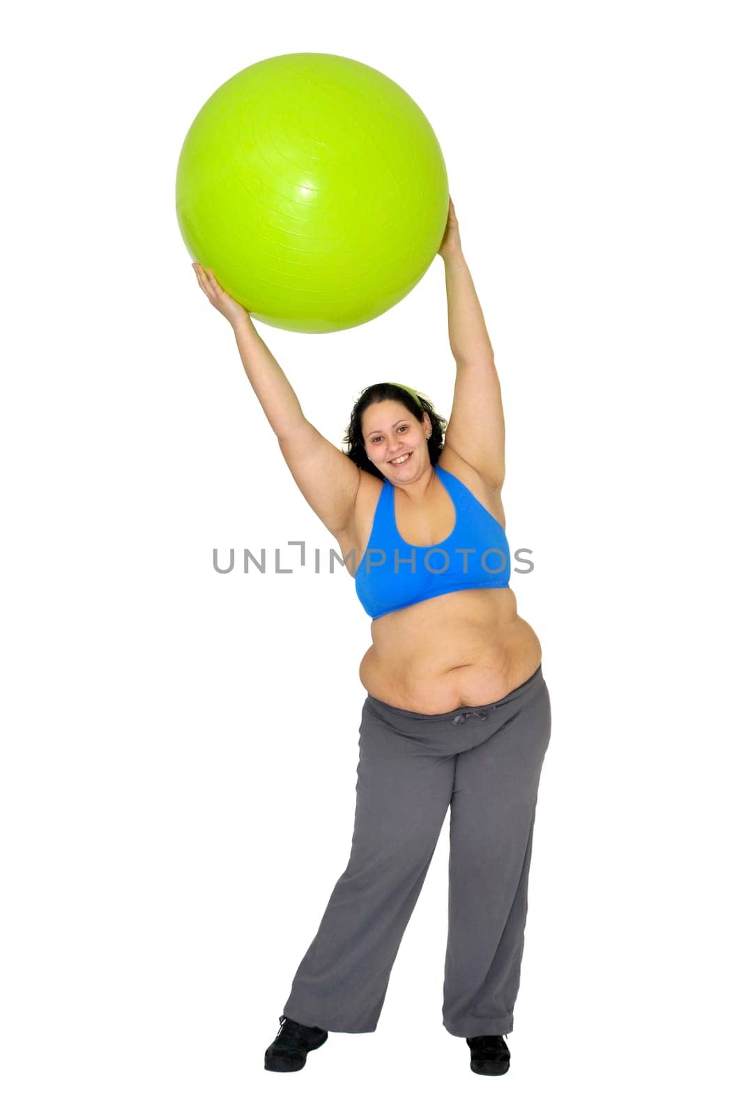 Large girl exercising with big fitness ball isolated in white
