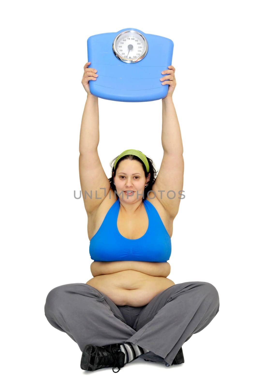 Large girl with weight scale isolated in white
