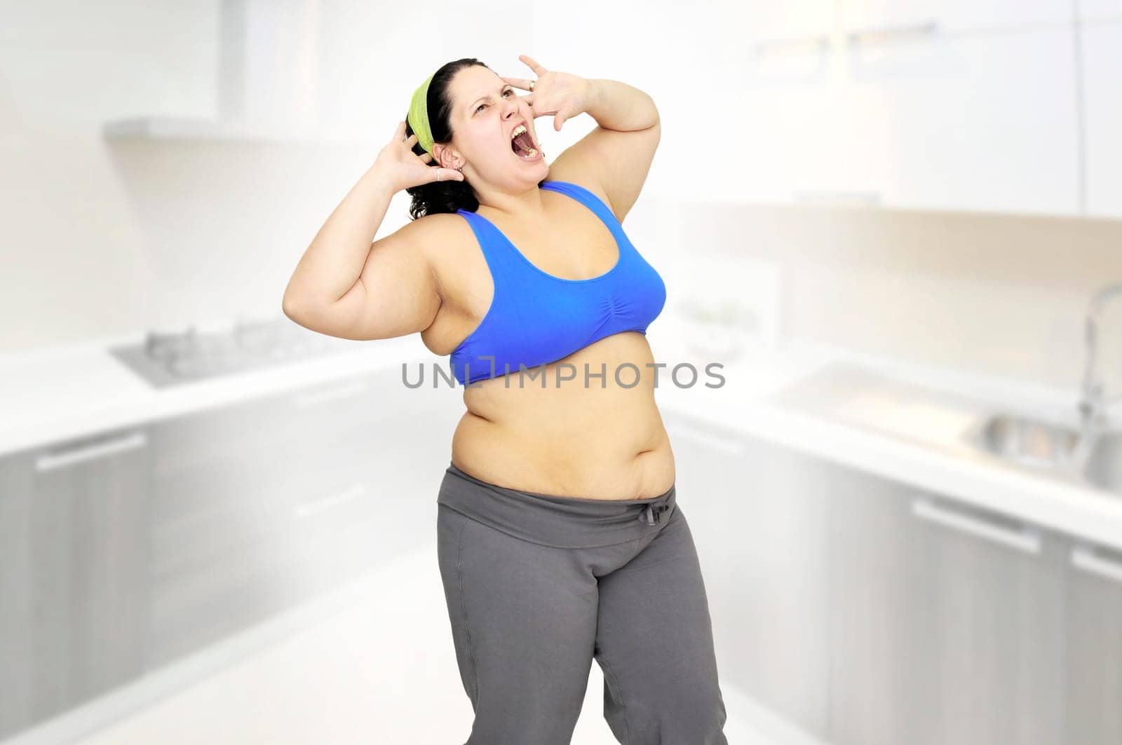 Desperate large girl screaming in the kitchen