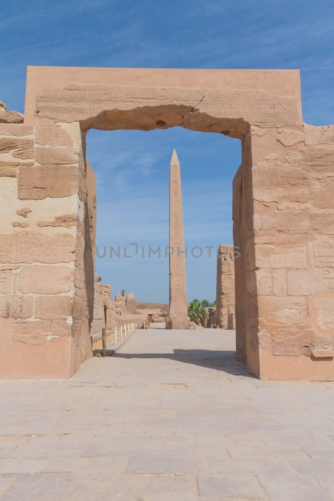 View of the obelisk at Karnak temple in Luxor through an archway (Egypt)
