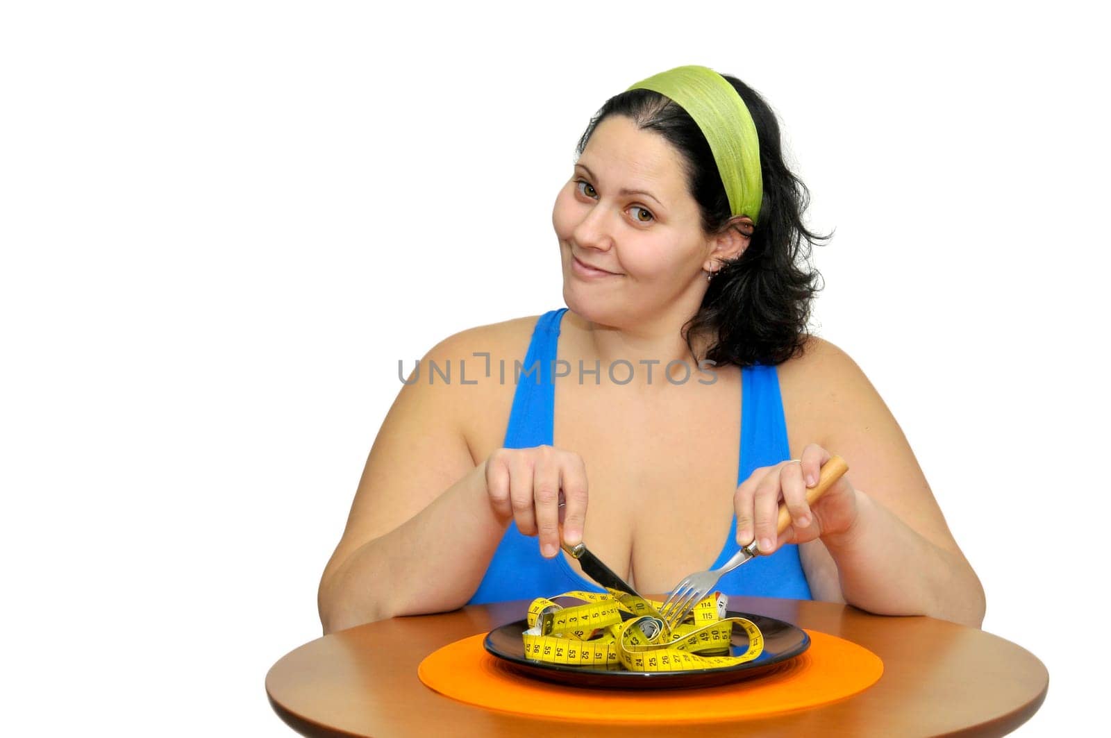 Large girl eating a measuring tape isolated in white