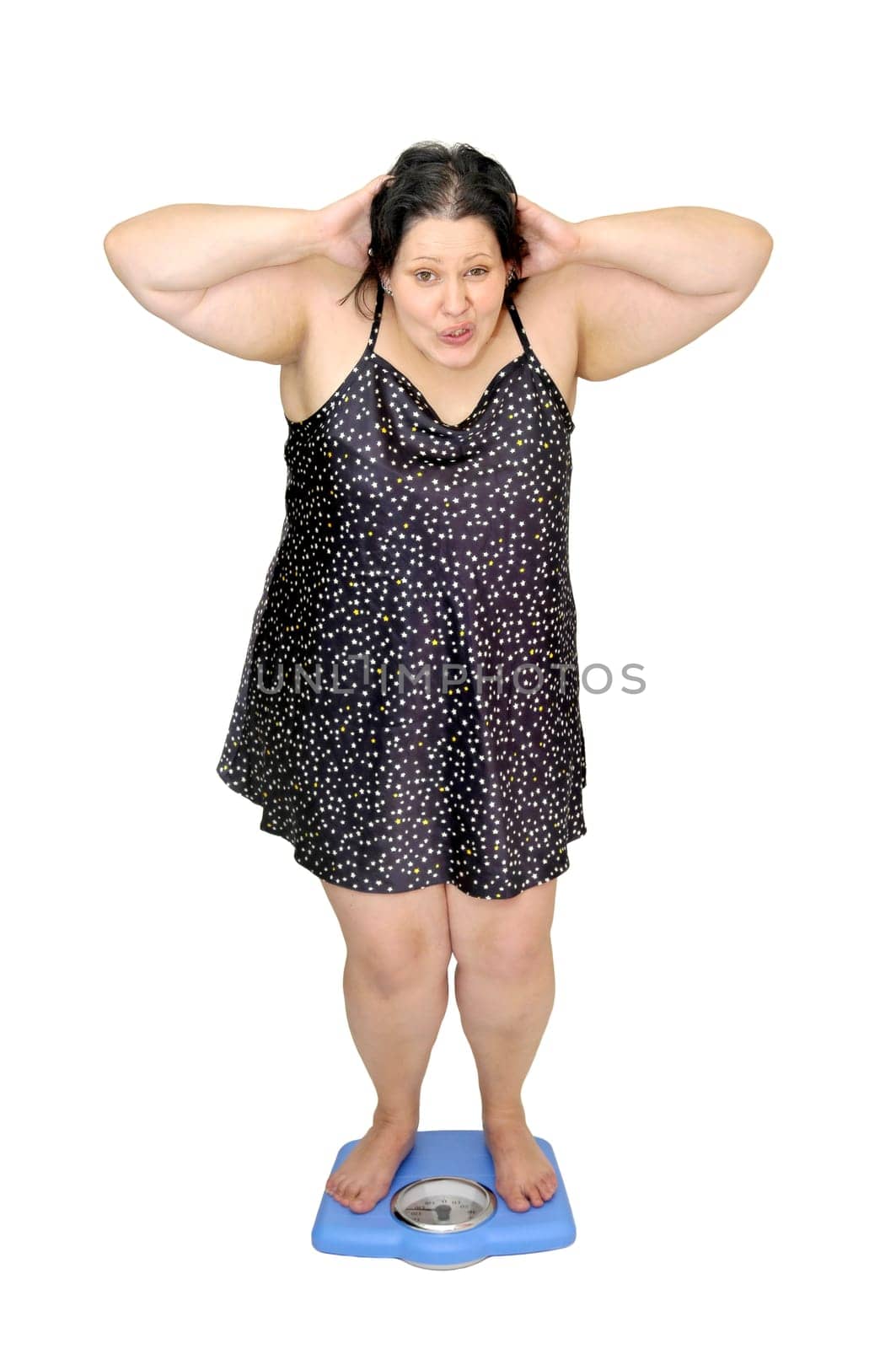 Large girl in nightie holding a scale isolated in white