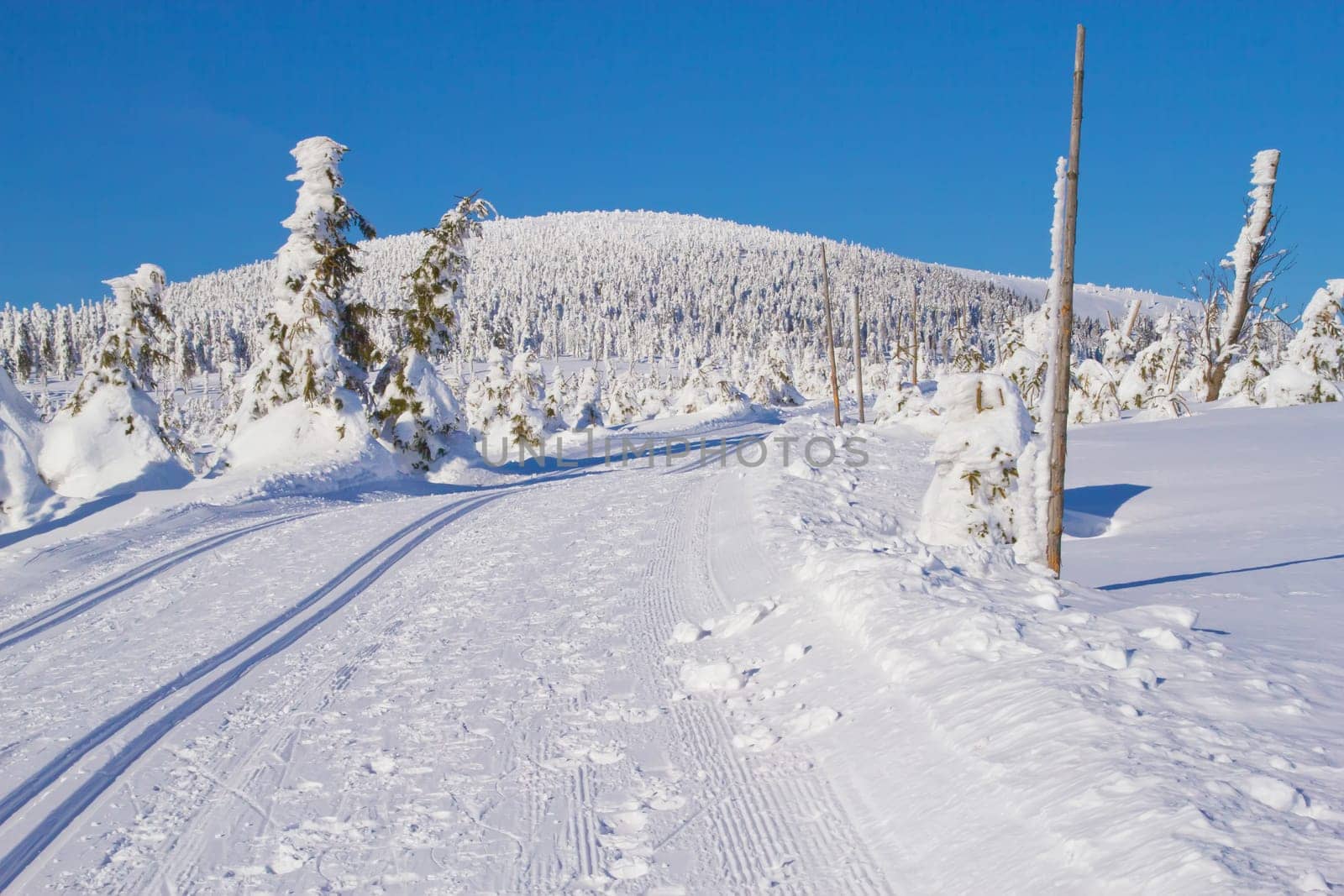 Winter mountain landscape scenery with cross country skiing way. Horizontally. (Mountains Jeseniky, Czech Republic)