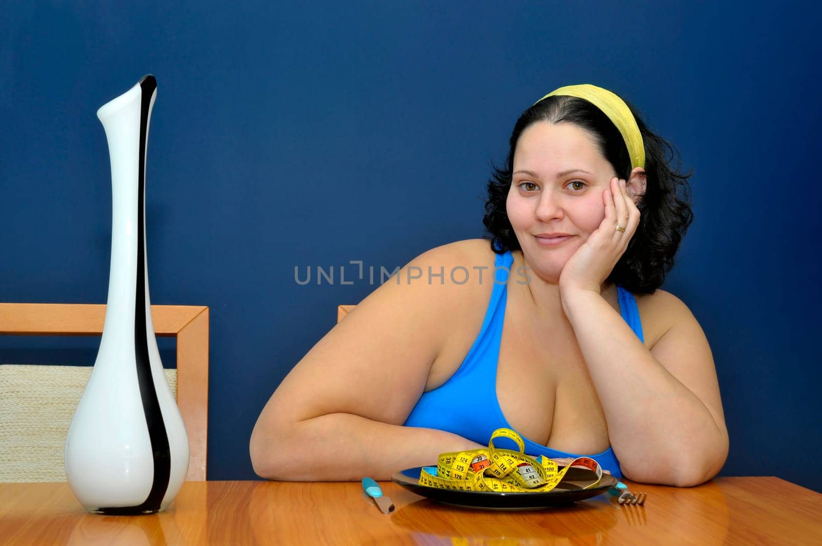 Large girl eating a measuring tape