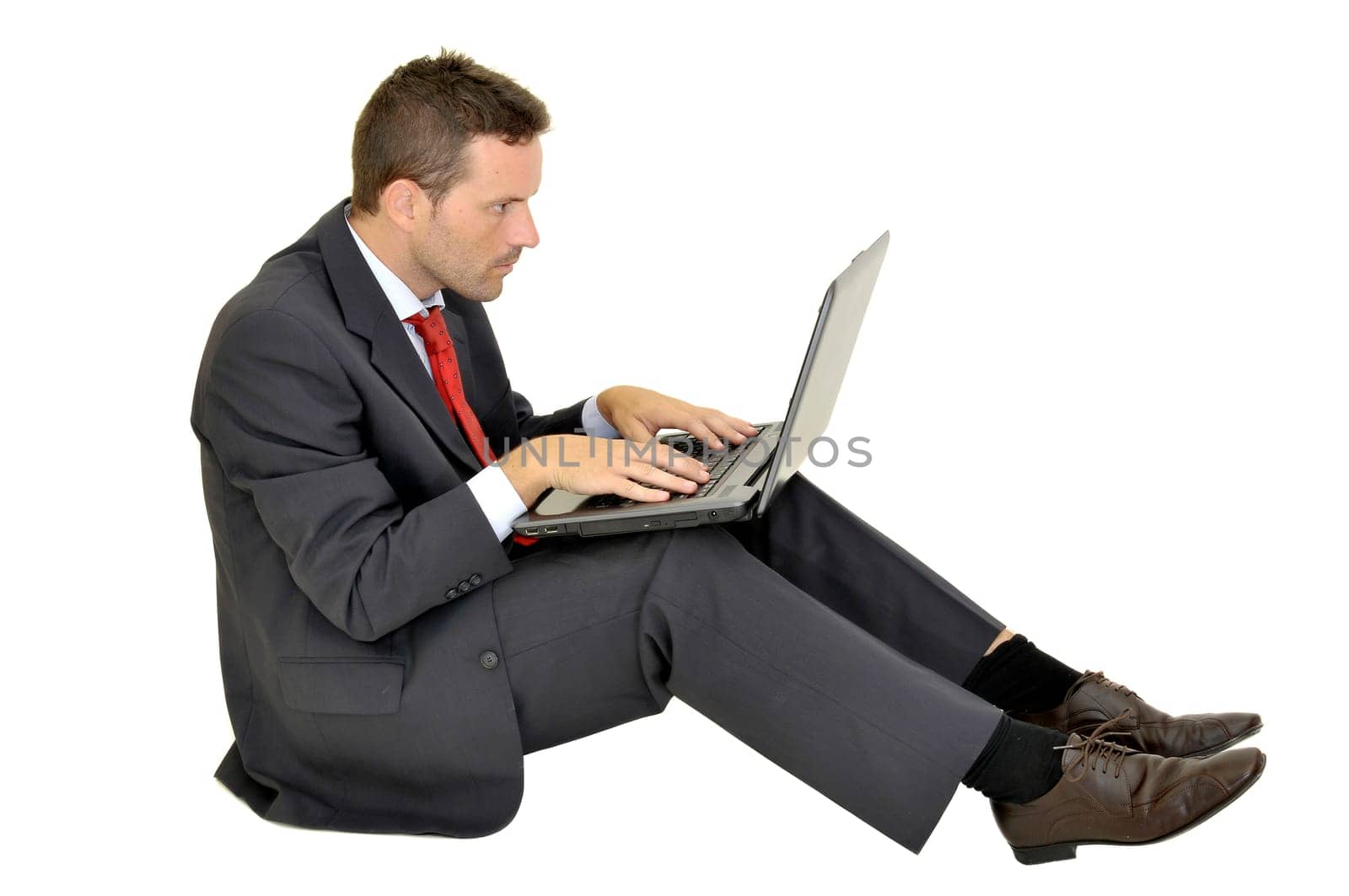 Young businessman with laptop isolated in white