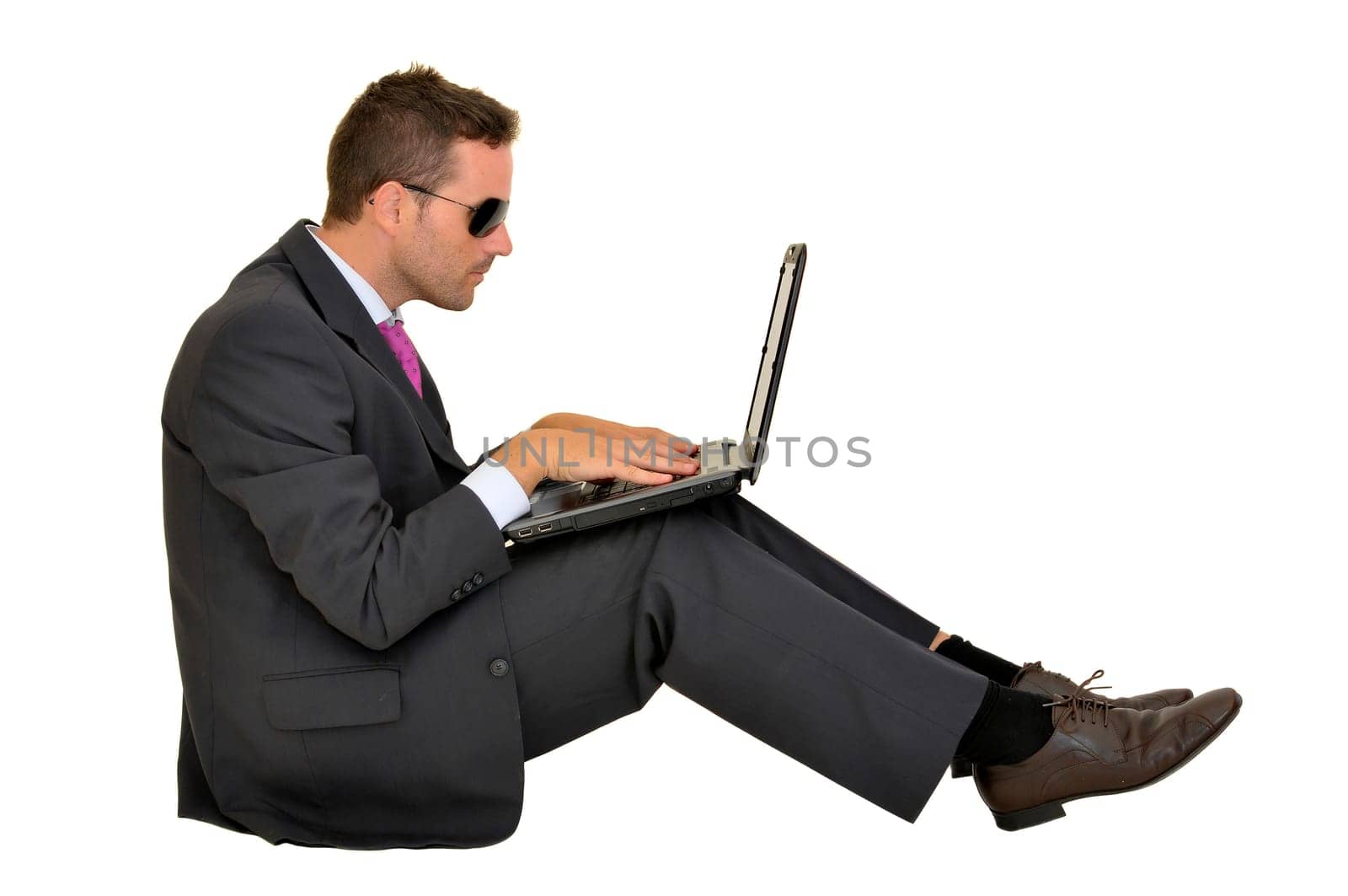 Young businessman with laptop isolated in white