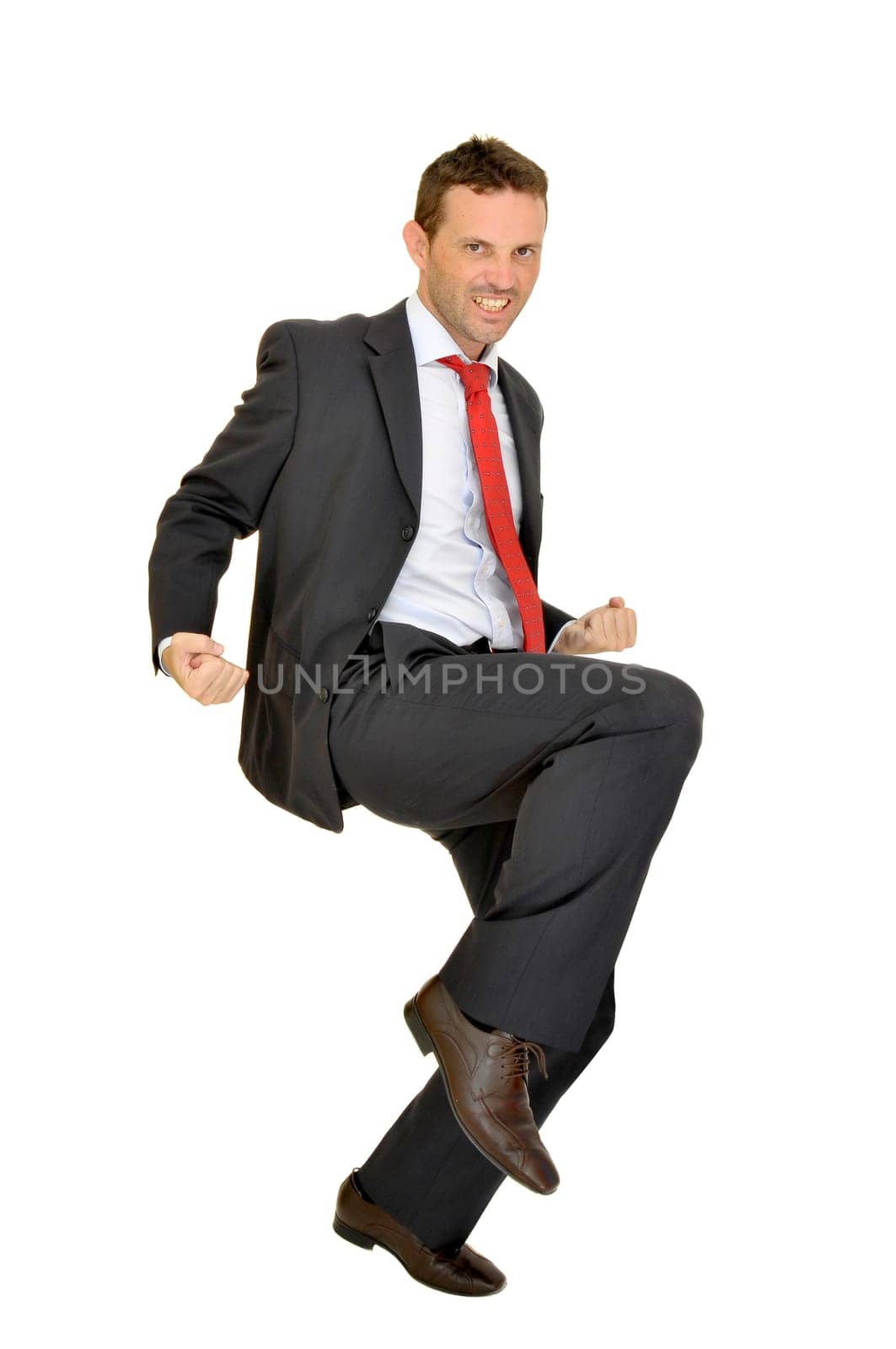 Young businessman jumping isolated in white