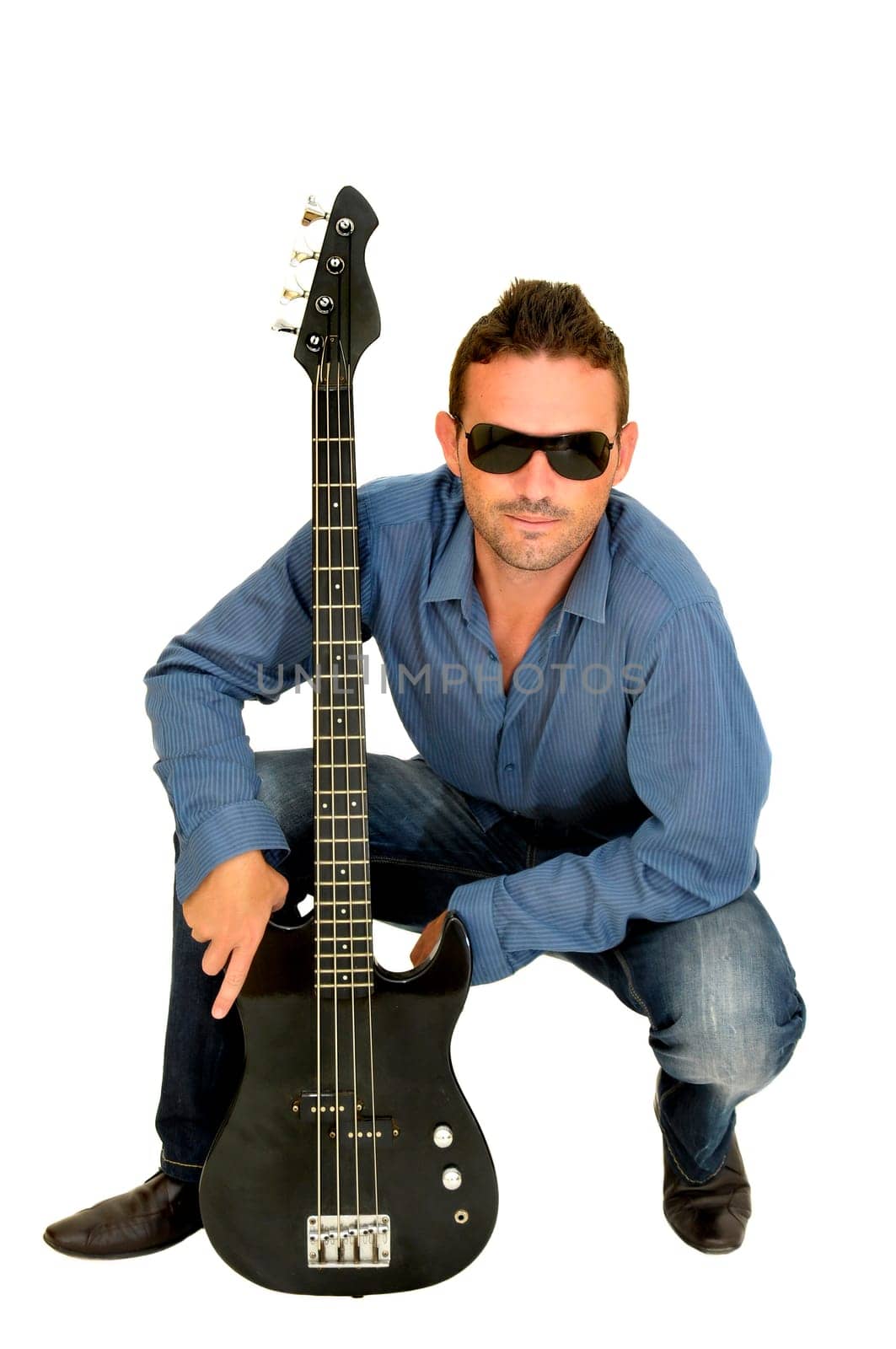 Young man posing with a guitar