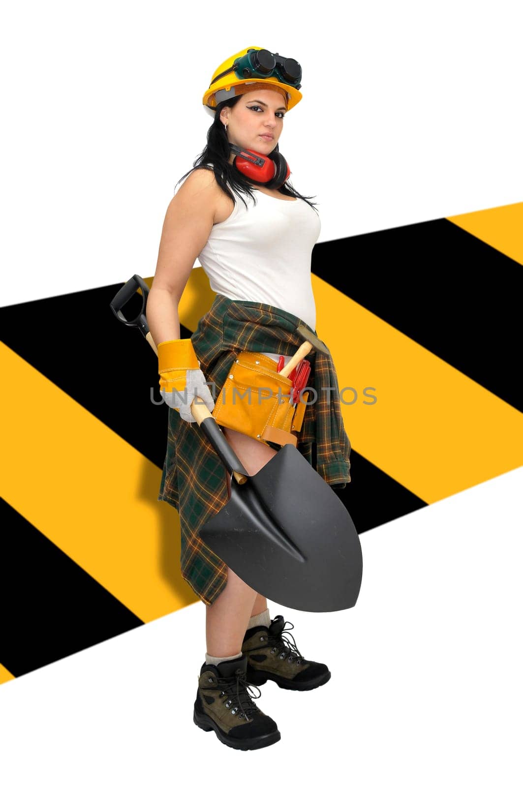 Young sexy construction worker girl with a shovel isolated in white