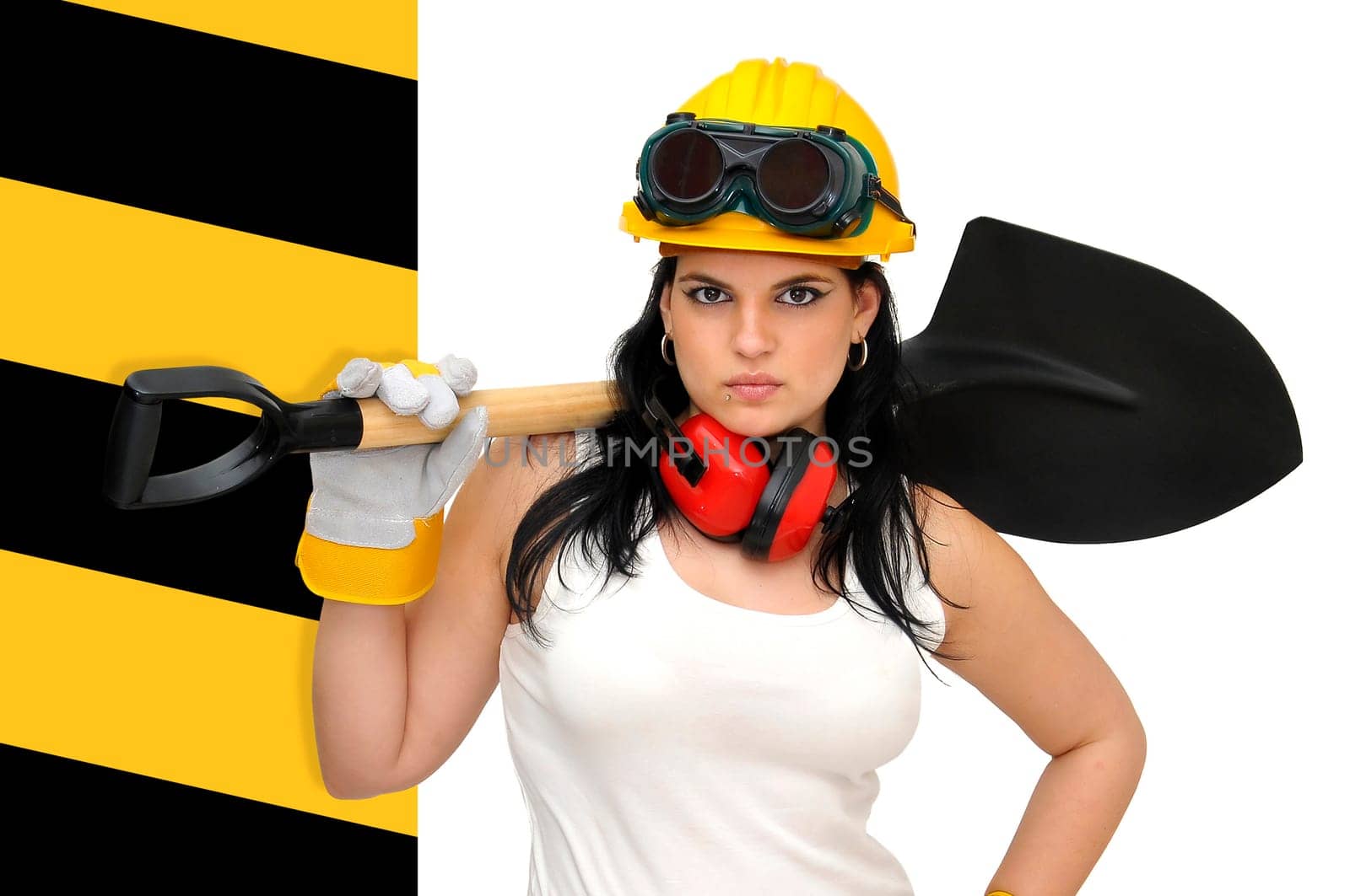 Young sexy construction worker girl with a shovel isolated in white