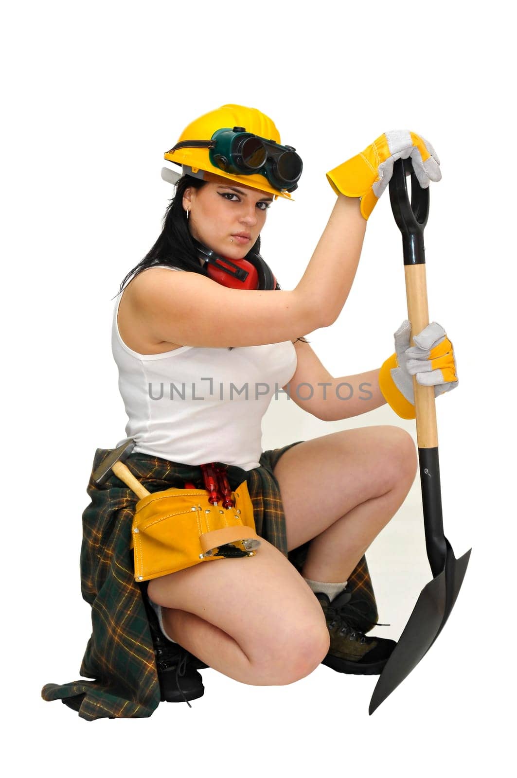 Young sexy construction worker girl with a shovel isolated in white