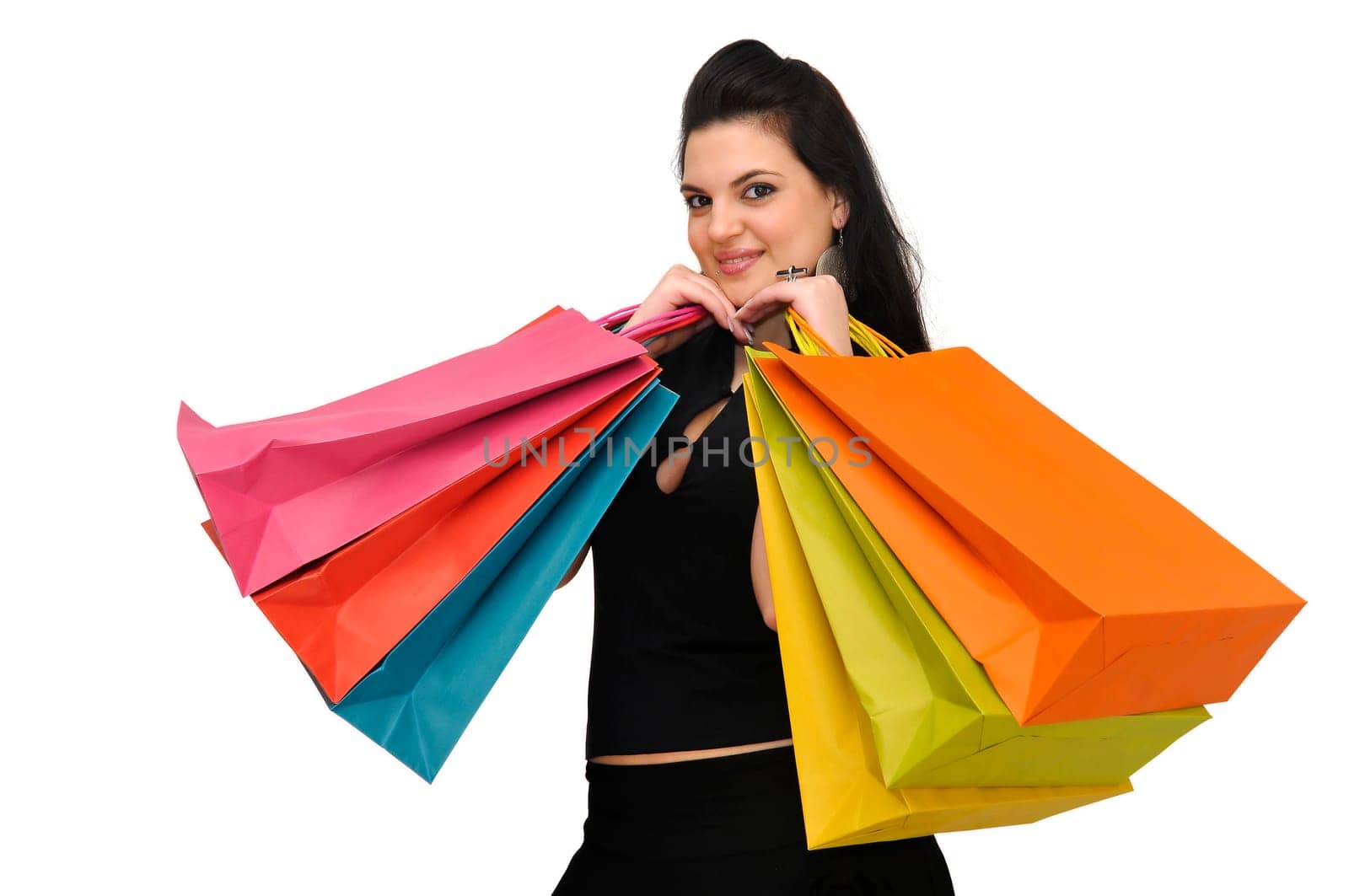 Sexy woman in black dress with colorful bags isolated in white