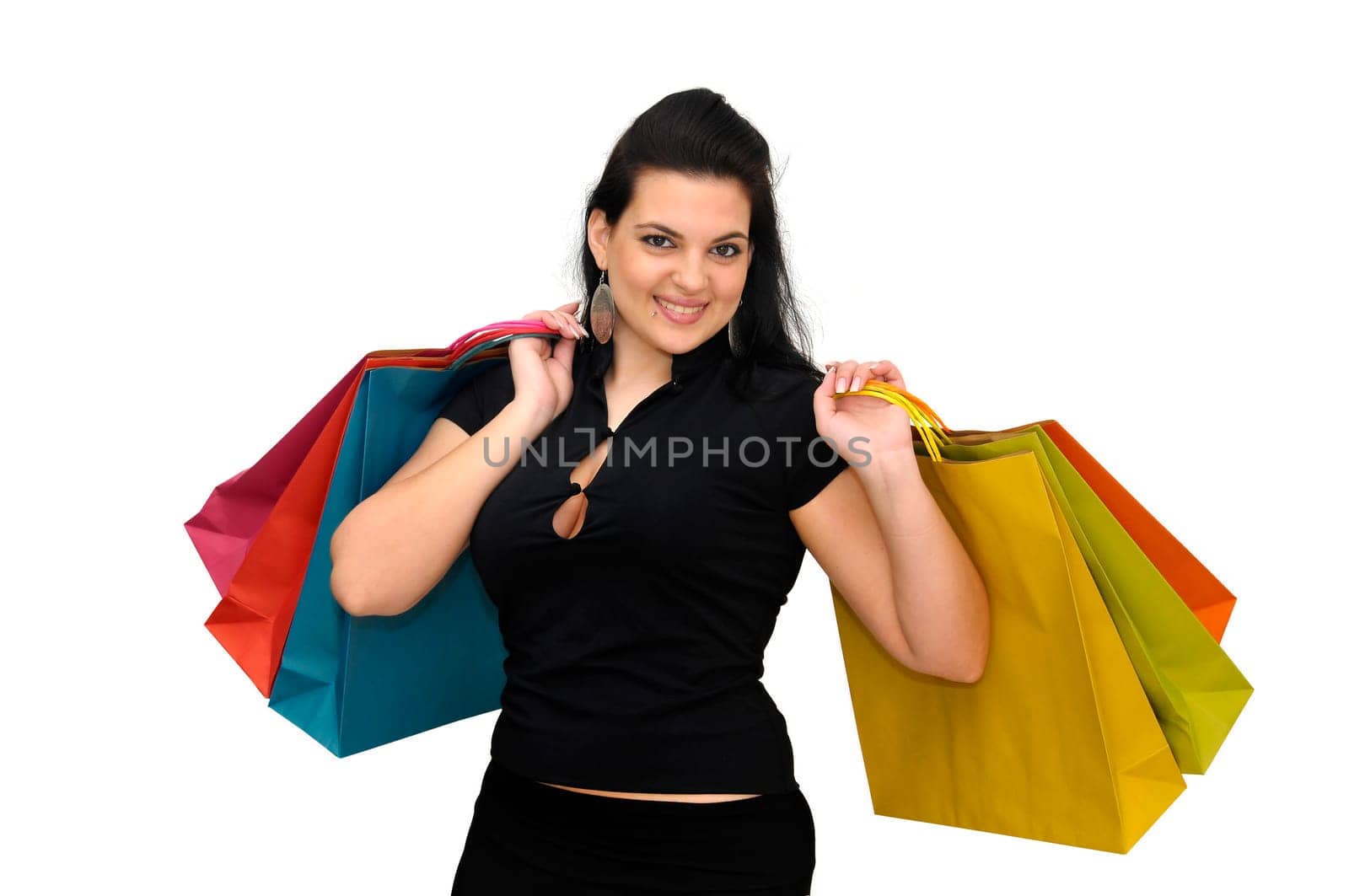 Sexy woman in black dress with colorful bags isolated in white