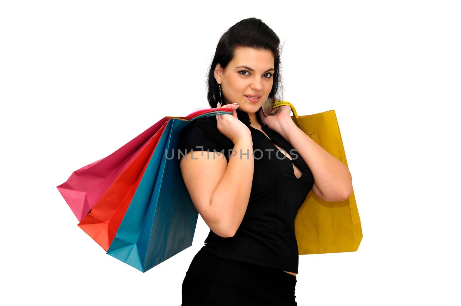Sexy woman in black dress with colorful bags isolated in white