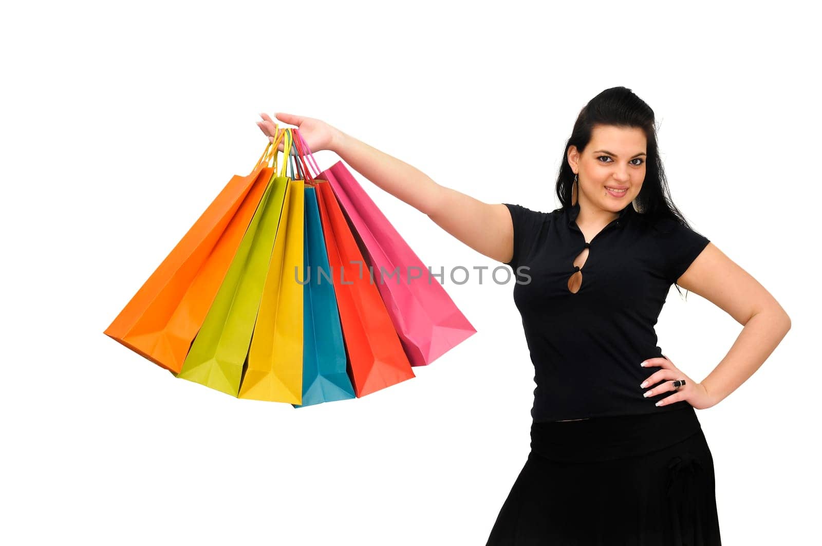 Sexy woman in black dress with colorful bags isolated in white