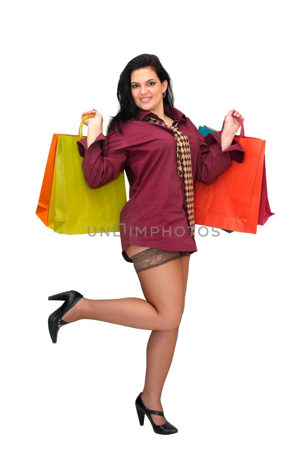 Sexy businesswoman with shopping bags isolated in white