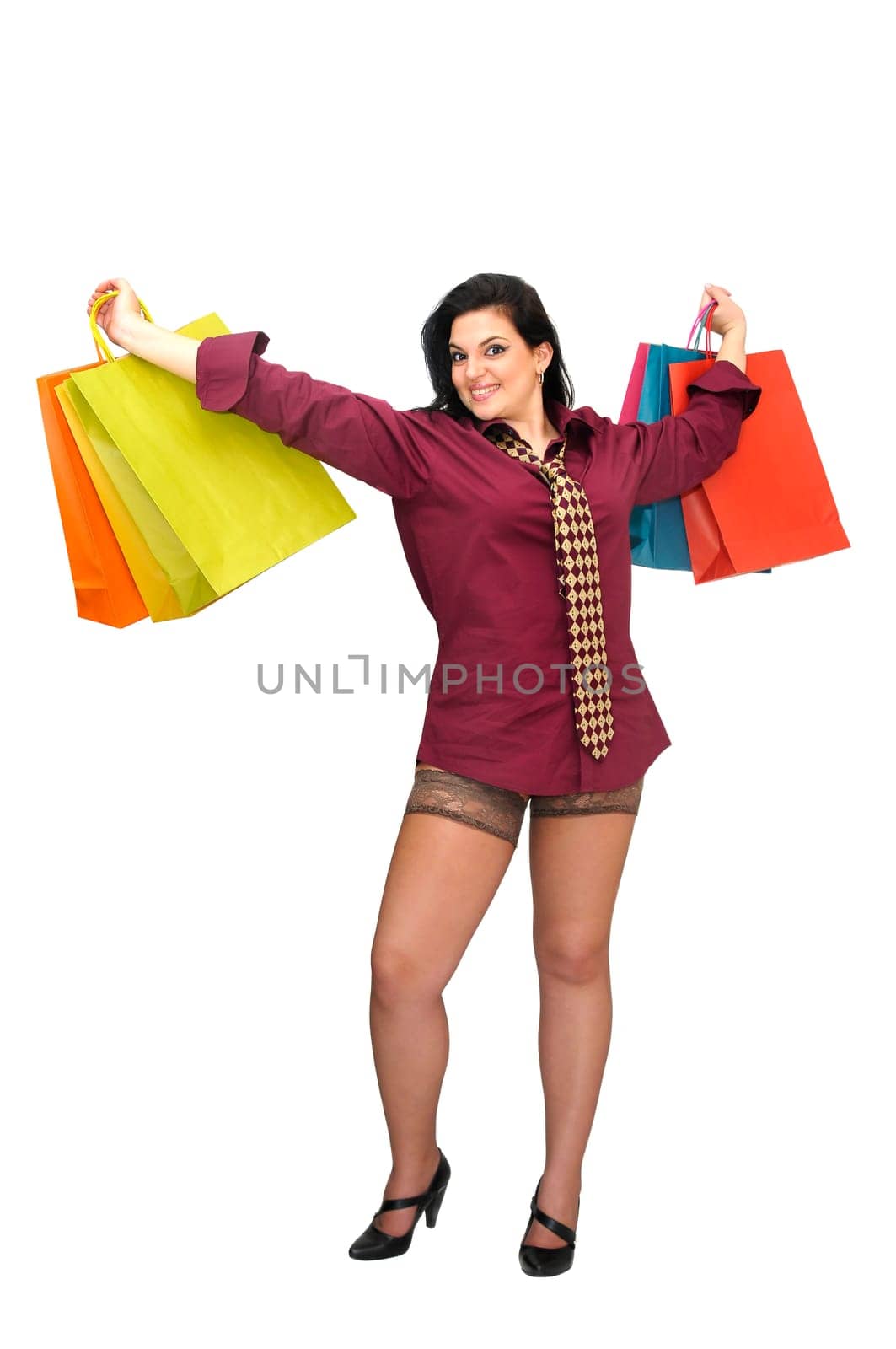 Sexy businesswoman with shopping bags isolated in white