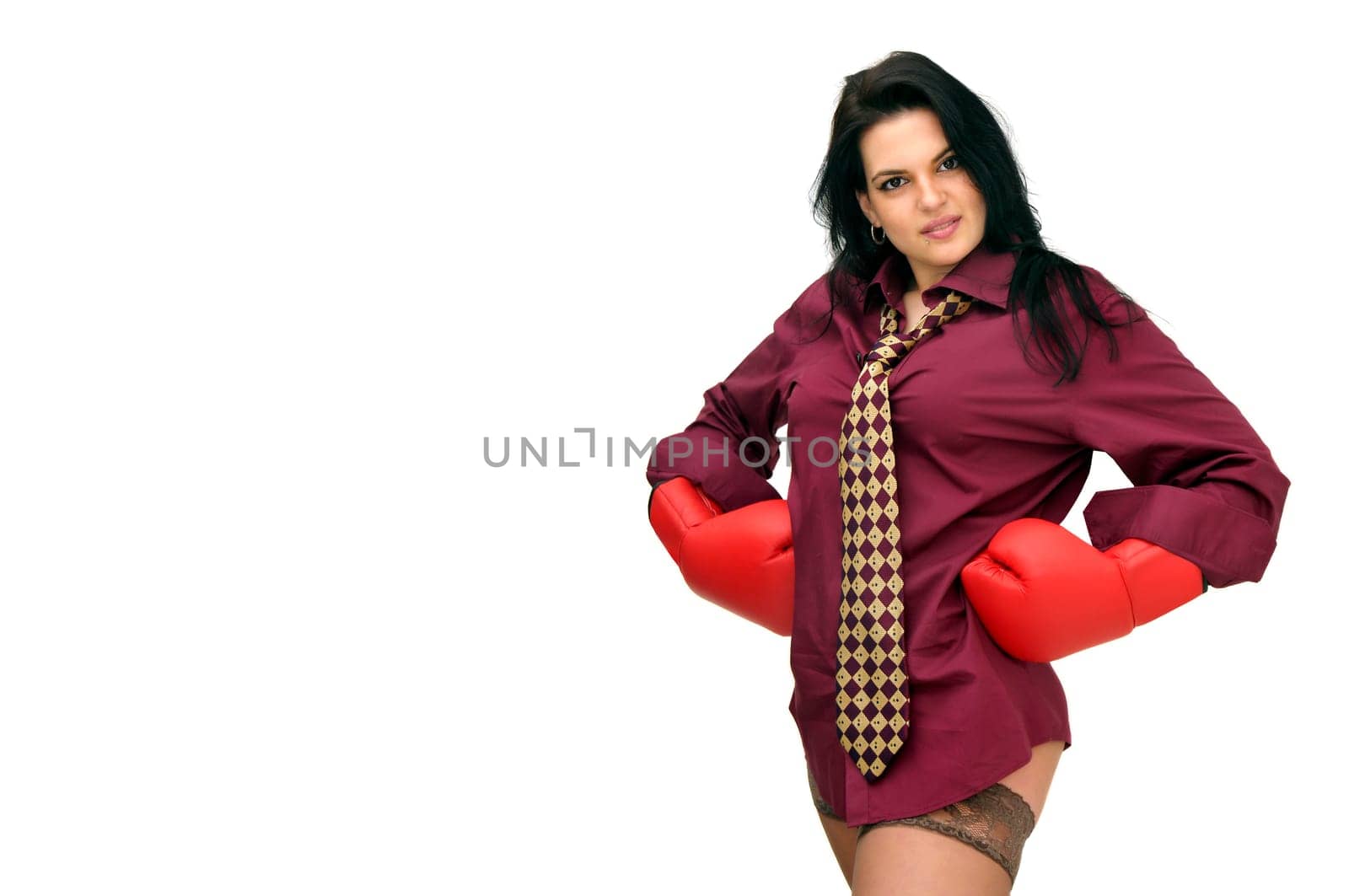 Sexy businesswoman with boxing gloves isolated in white