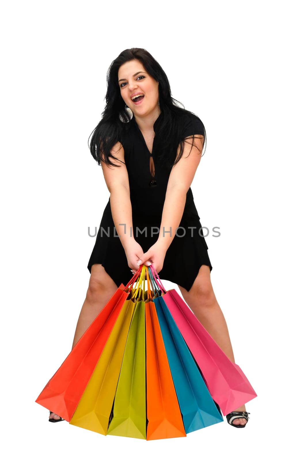 Sexy woman in black dress with colorful bags isolated in white