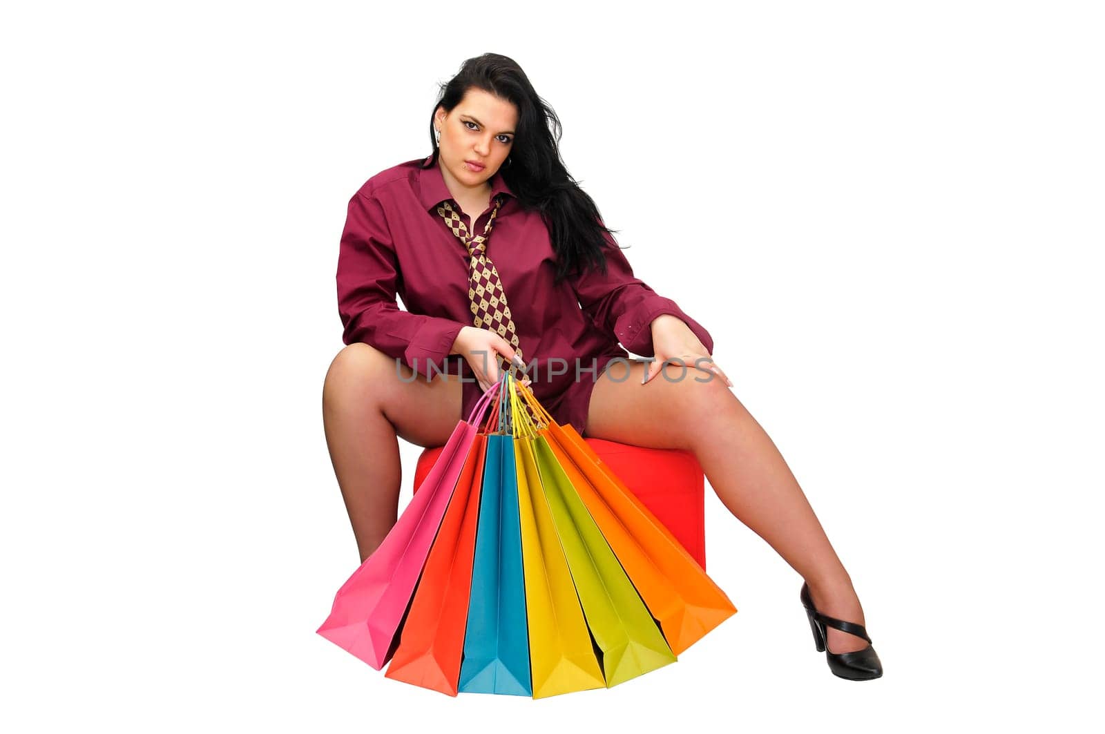 Sexy businesswoman with shopping bags isolated in white