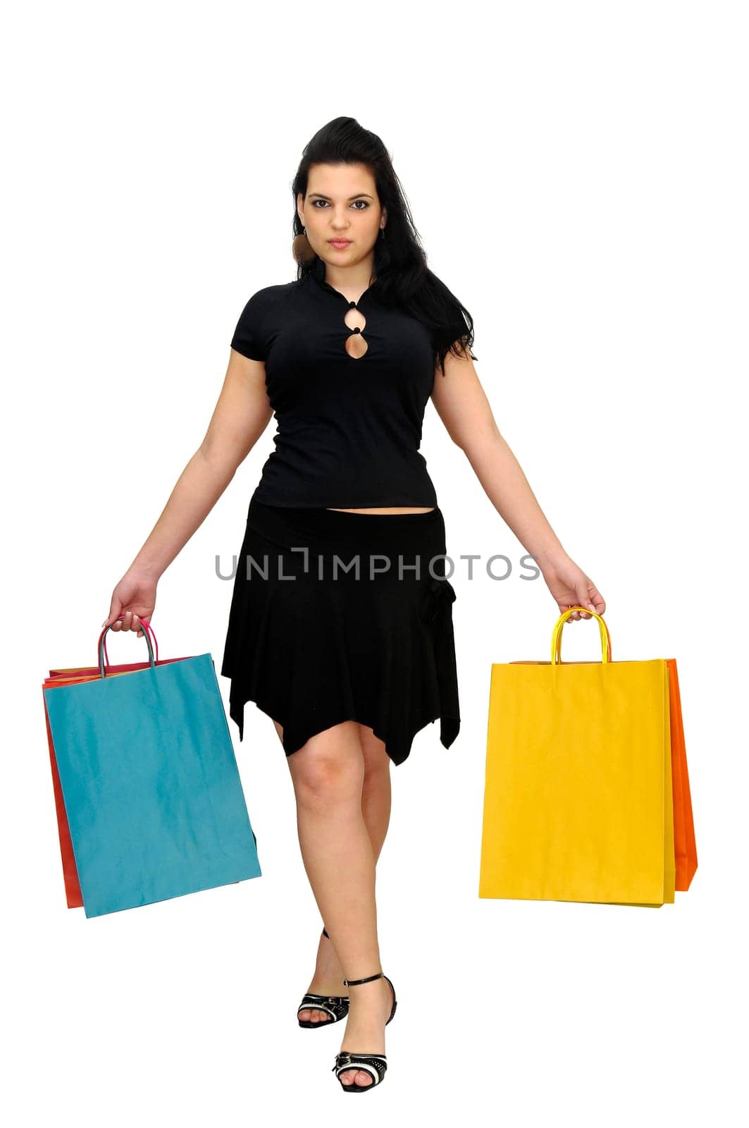 Sexy woman in black dress with colorful bags isolated in white
