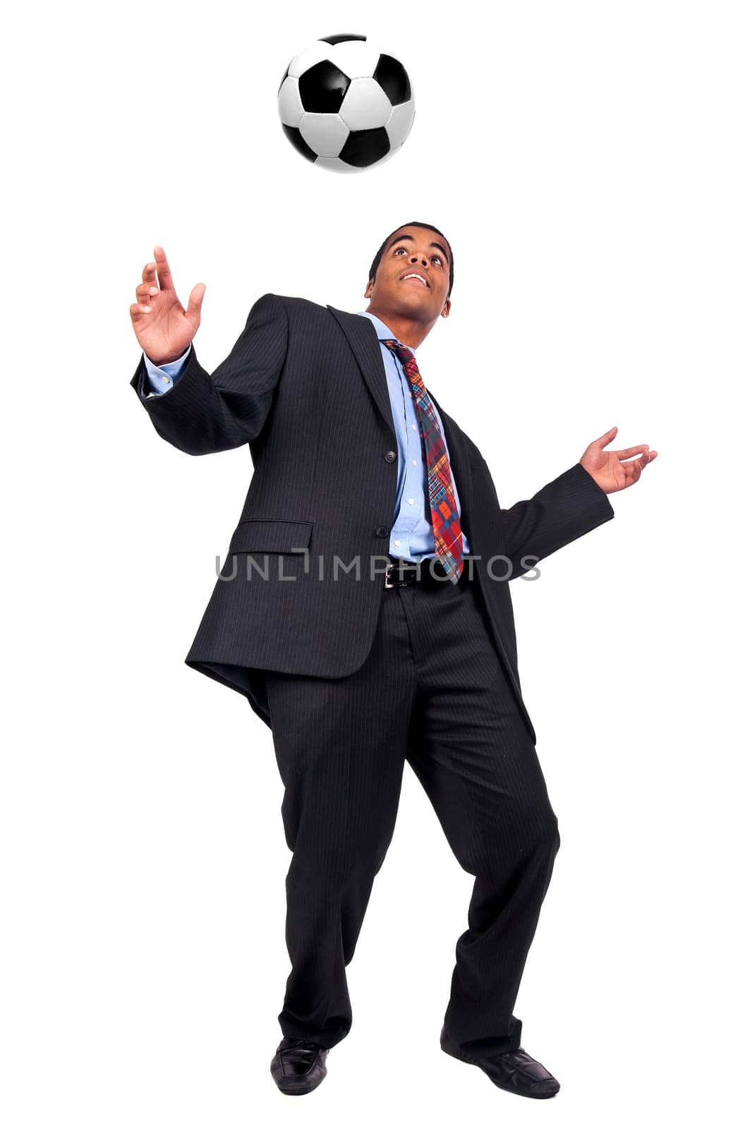 Businessman playing soccer isolated in white