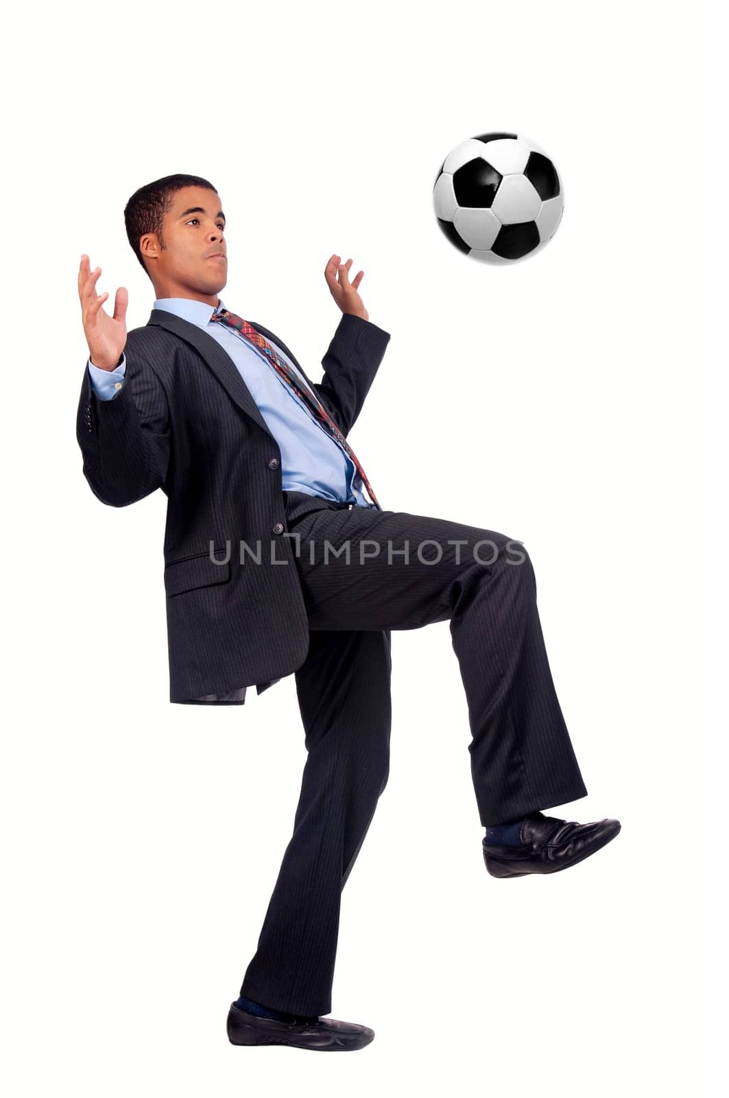 Businessman playing soccer isolated in white