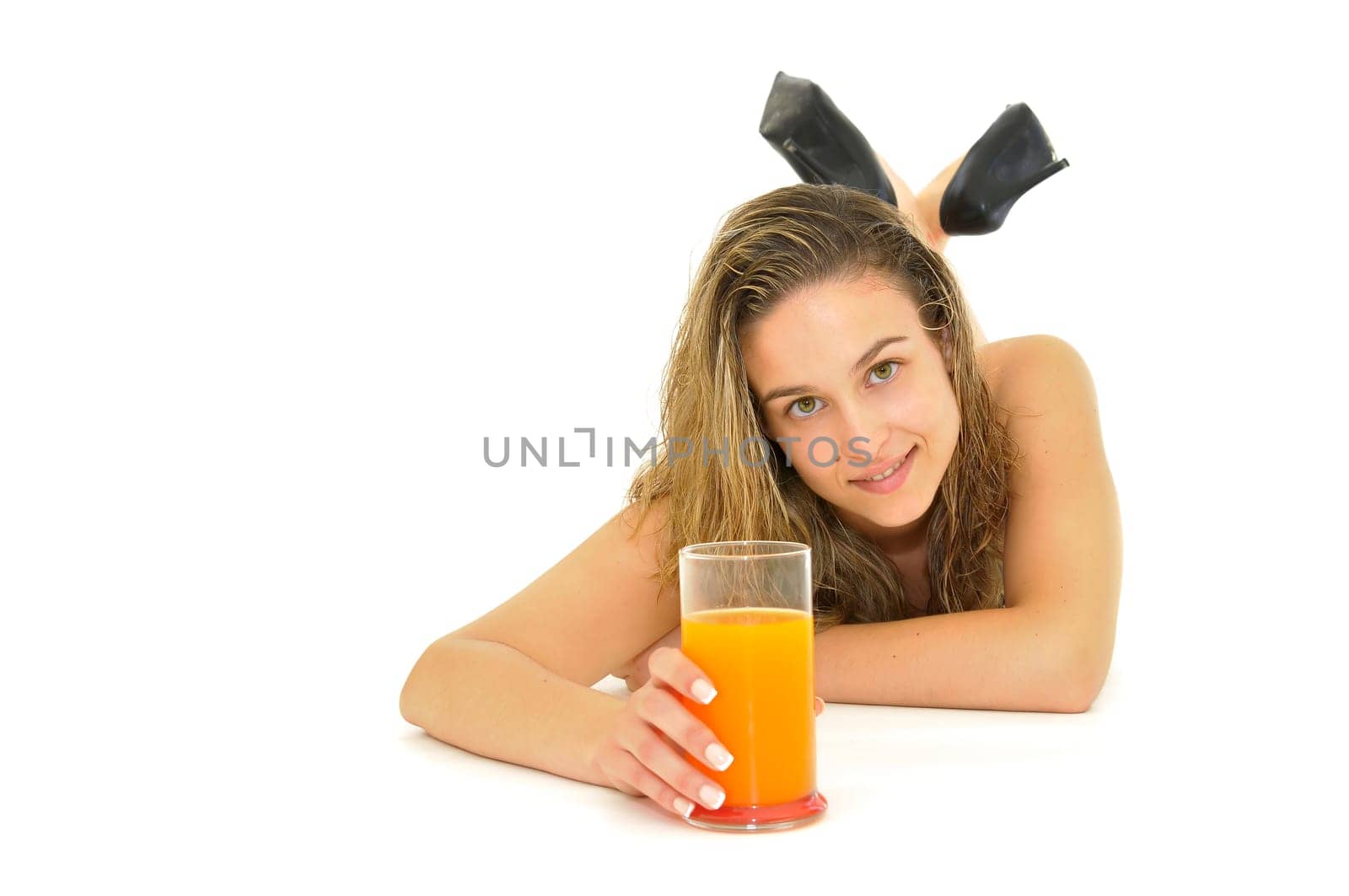 Sexy young girl with a natural juice glass isolated in white