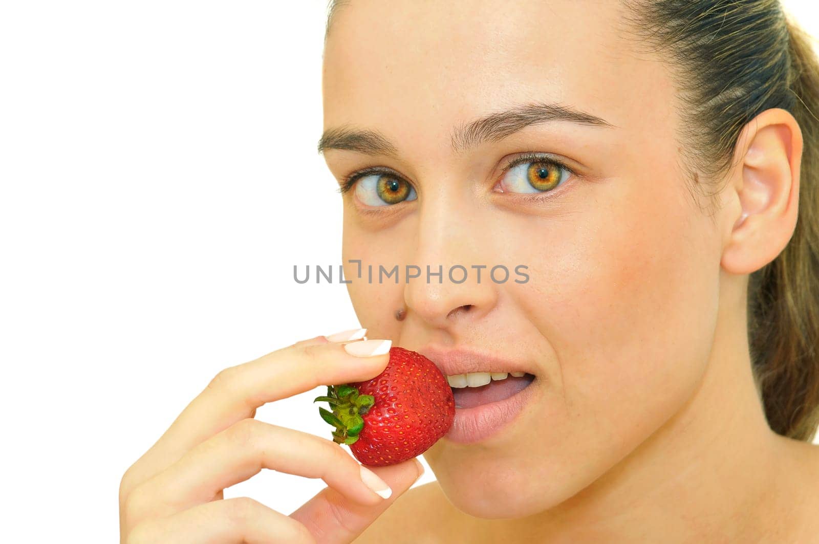 Sexy young girl eating a strawberry isolated in white