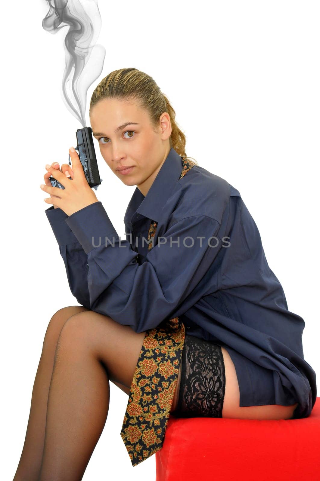 Sexy business woman with gun isolated in white