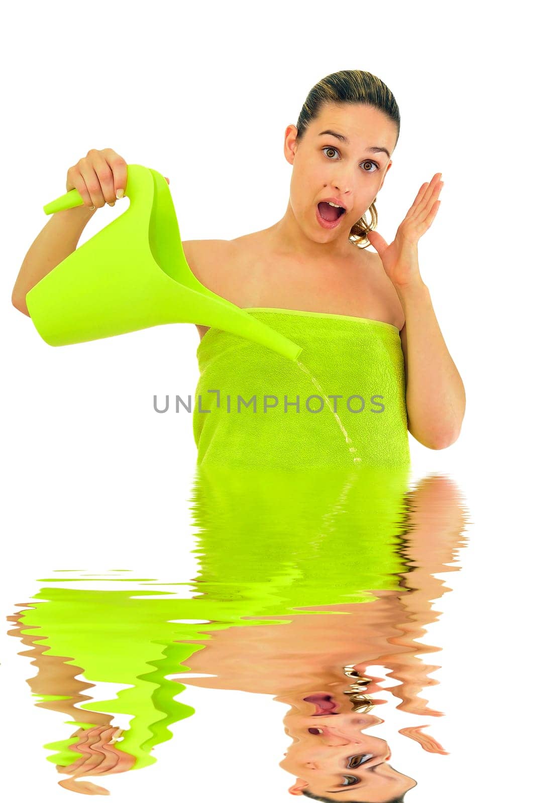 Sexy young girl with towel surprised, filling the image with water isolated in white