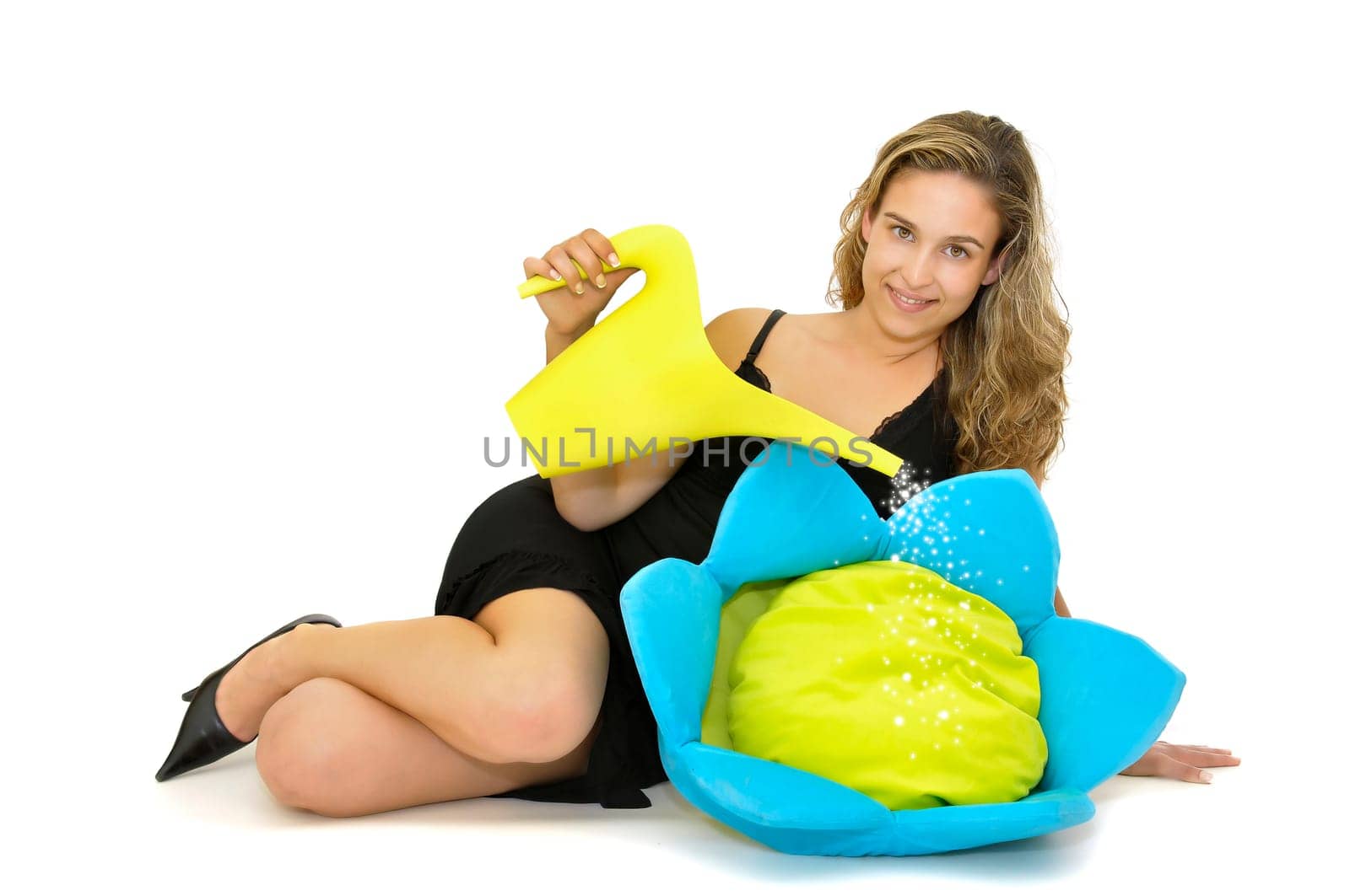Beautiful young woman posing with a black dress and a flower isolated in white