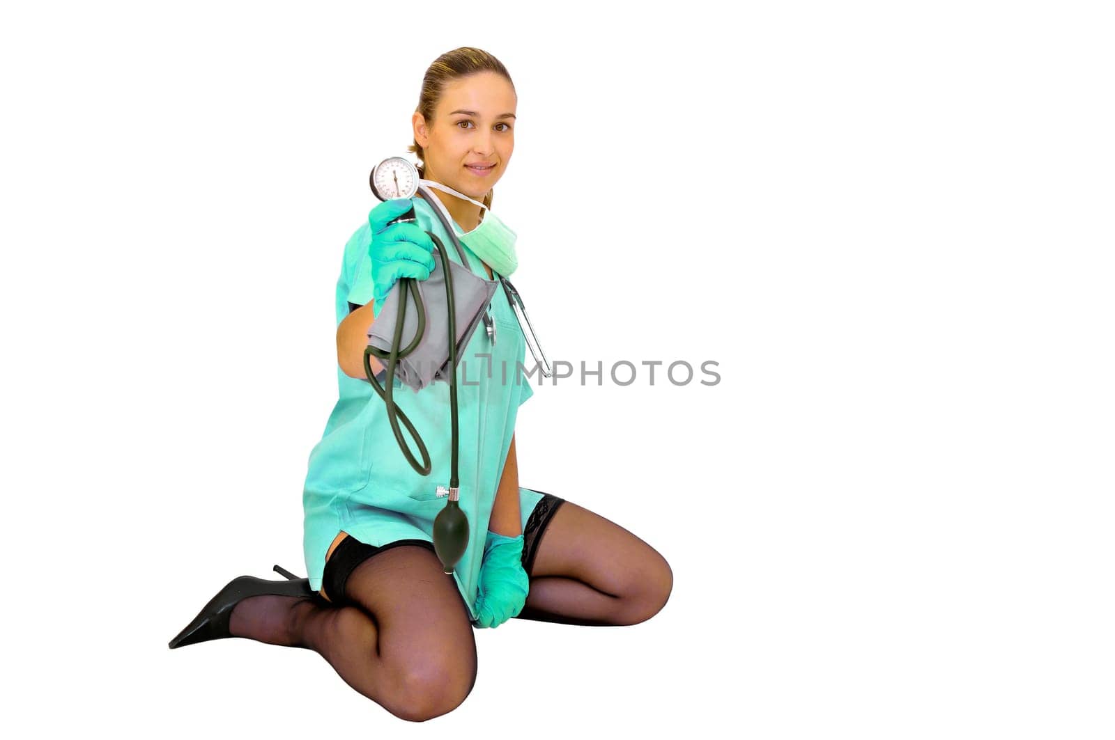 Sexy young doctor with blood pressure device posing against a white background