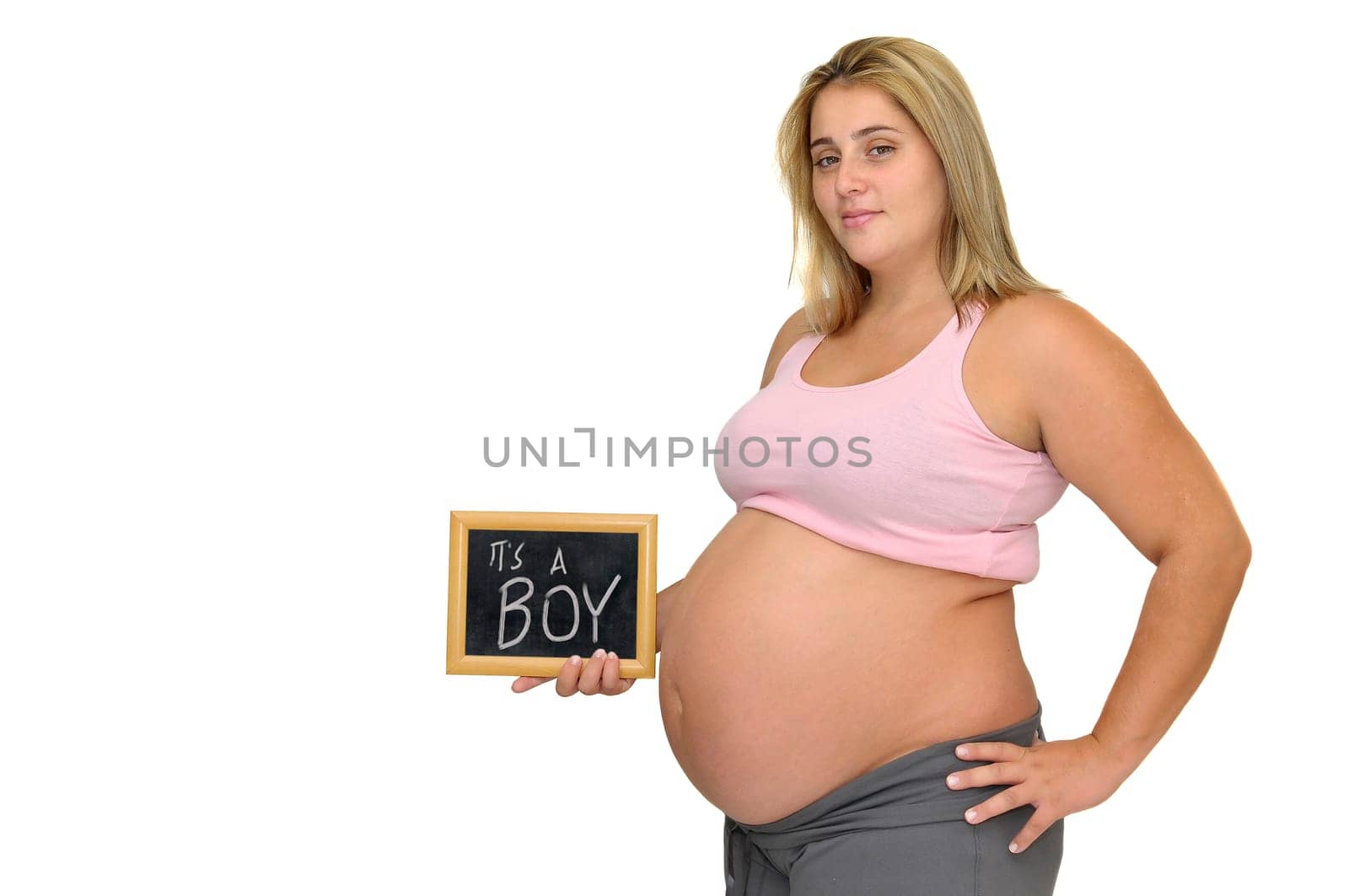 Pregnant woman holding a frame isolated in white