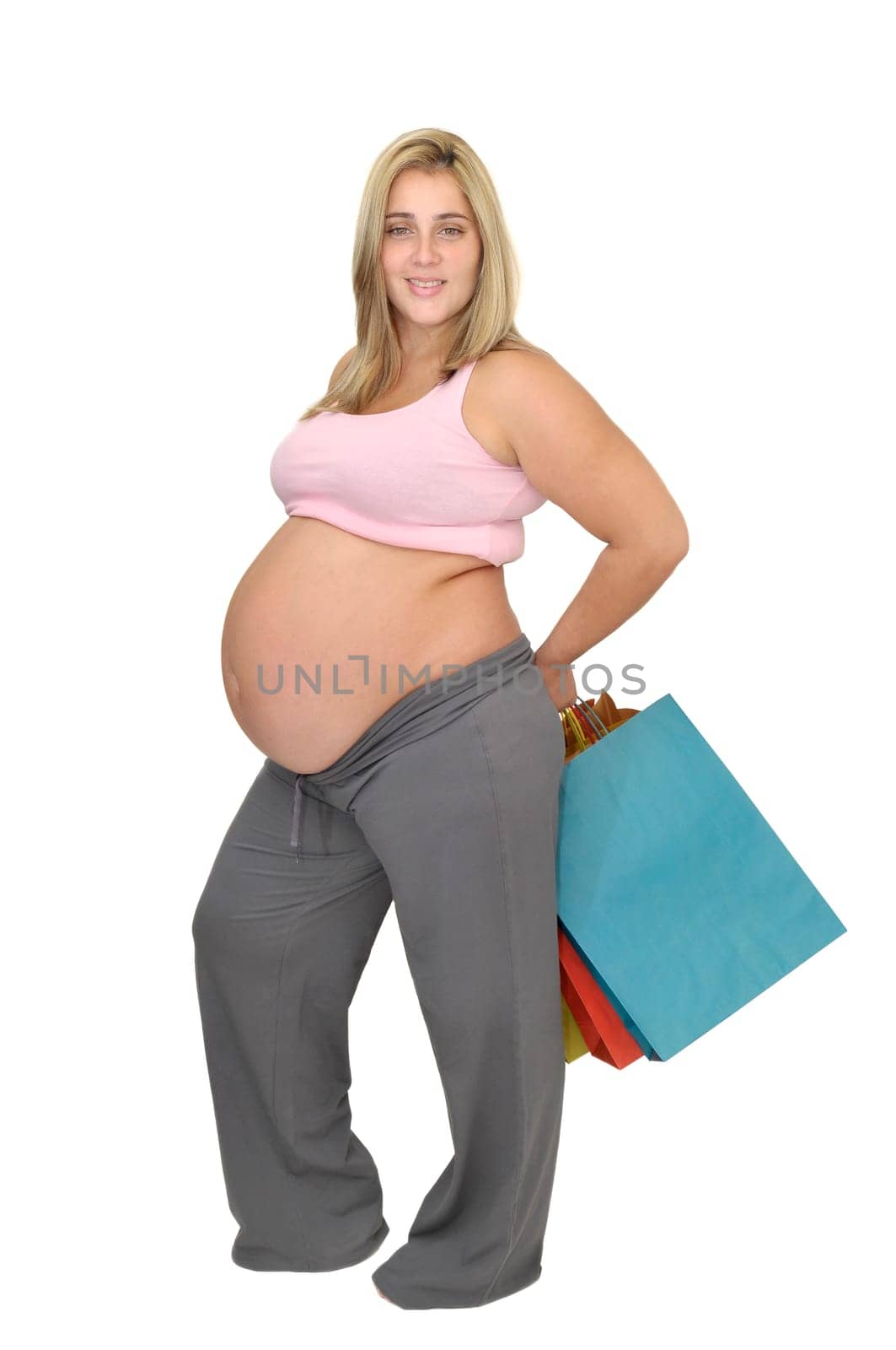 Pregnant woman with shopping bags isolated in white