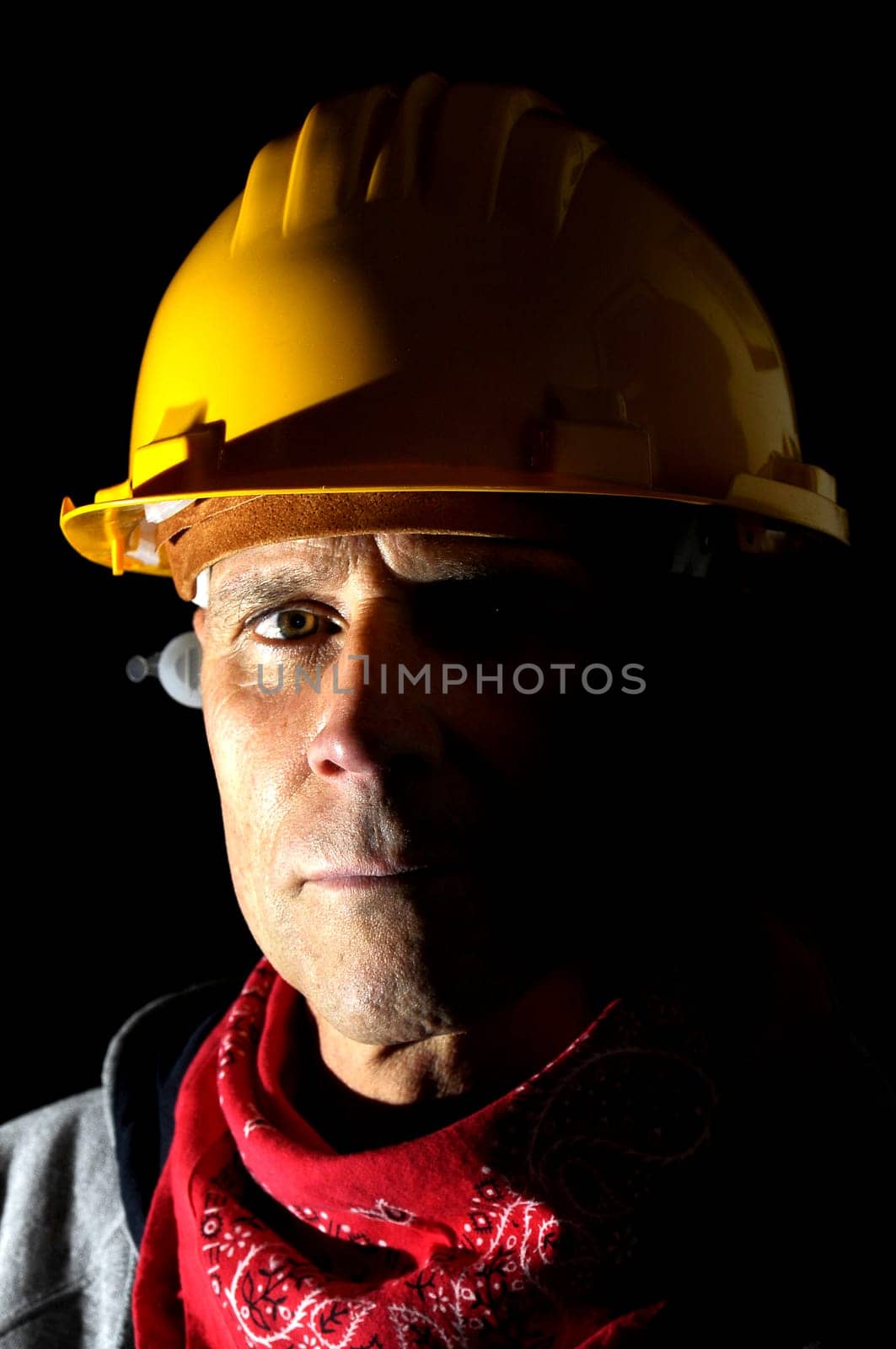 Portrait of a worker isolated in black