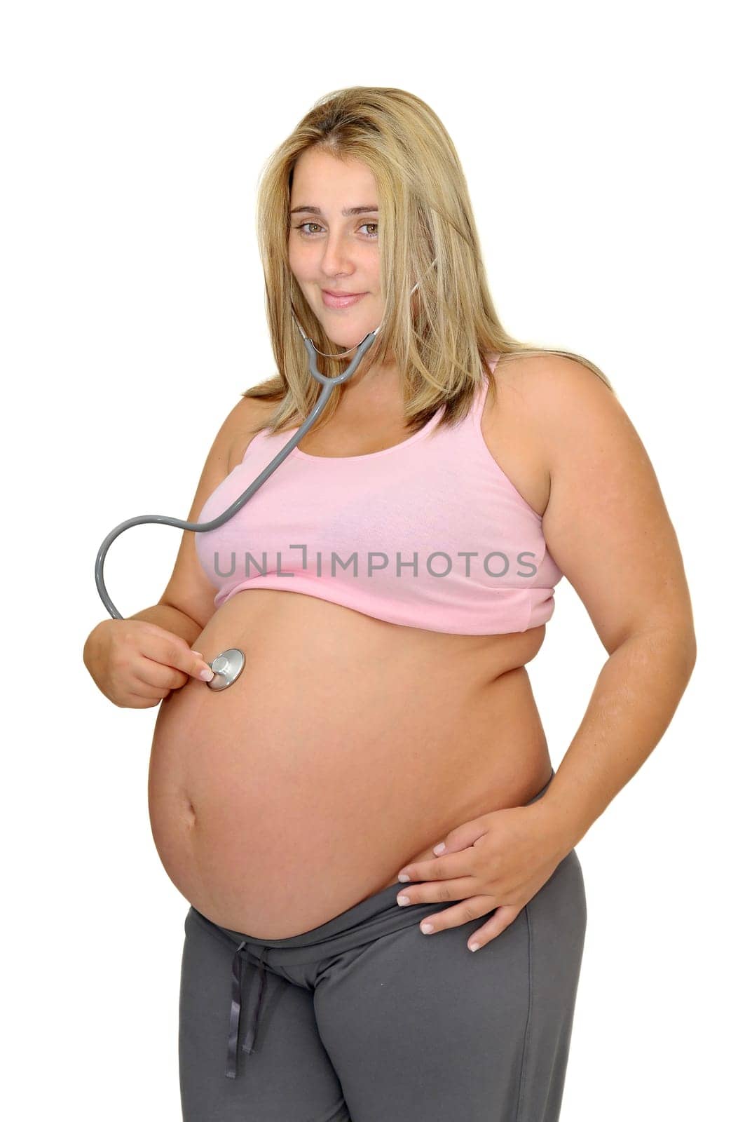 Pregnant woman with stethoscope isolated in white
