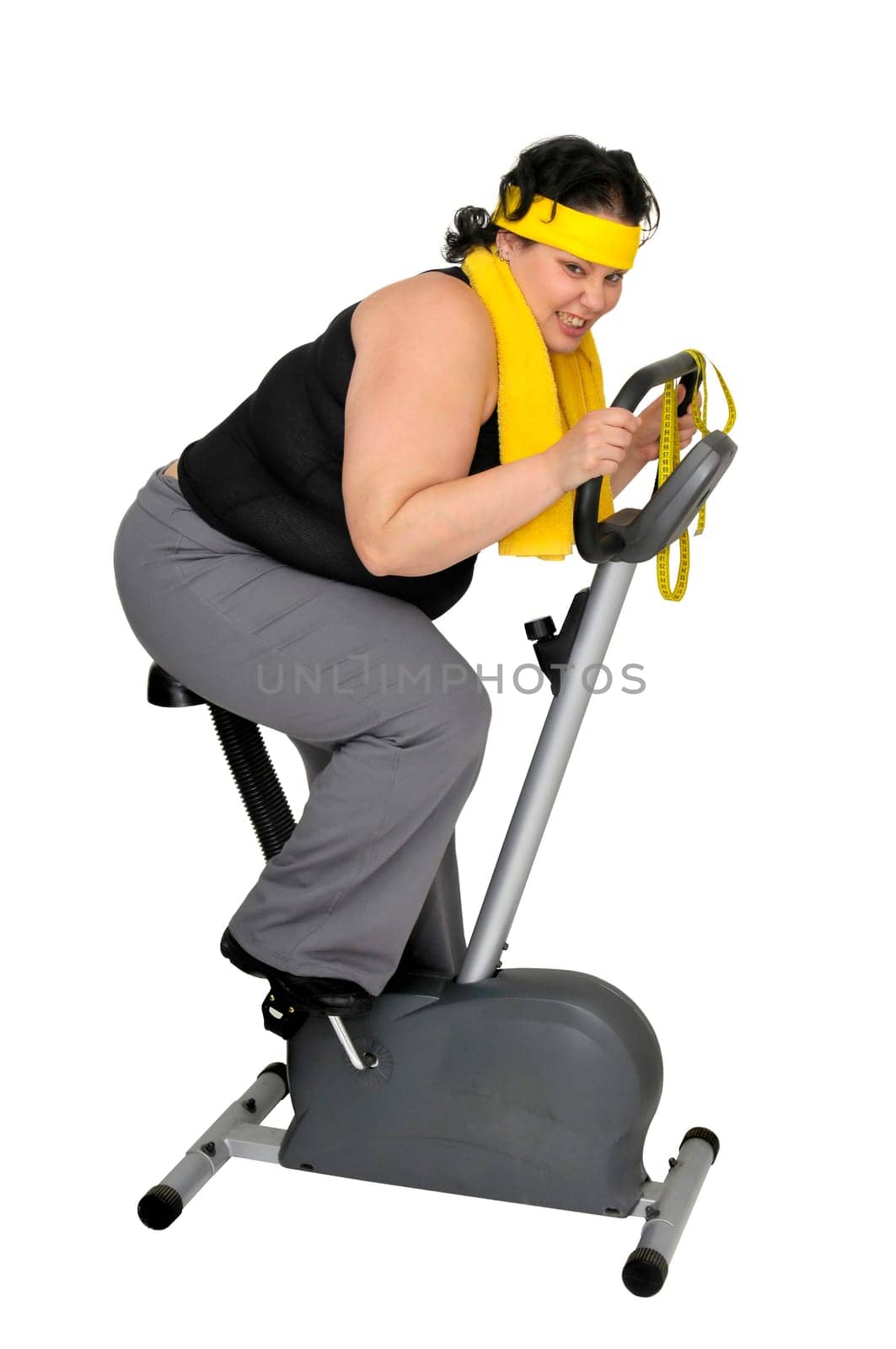 Large girl working out in a fitness bicycle