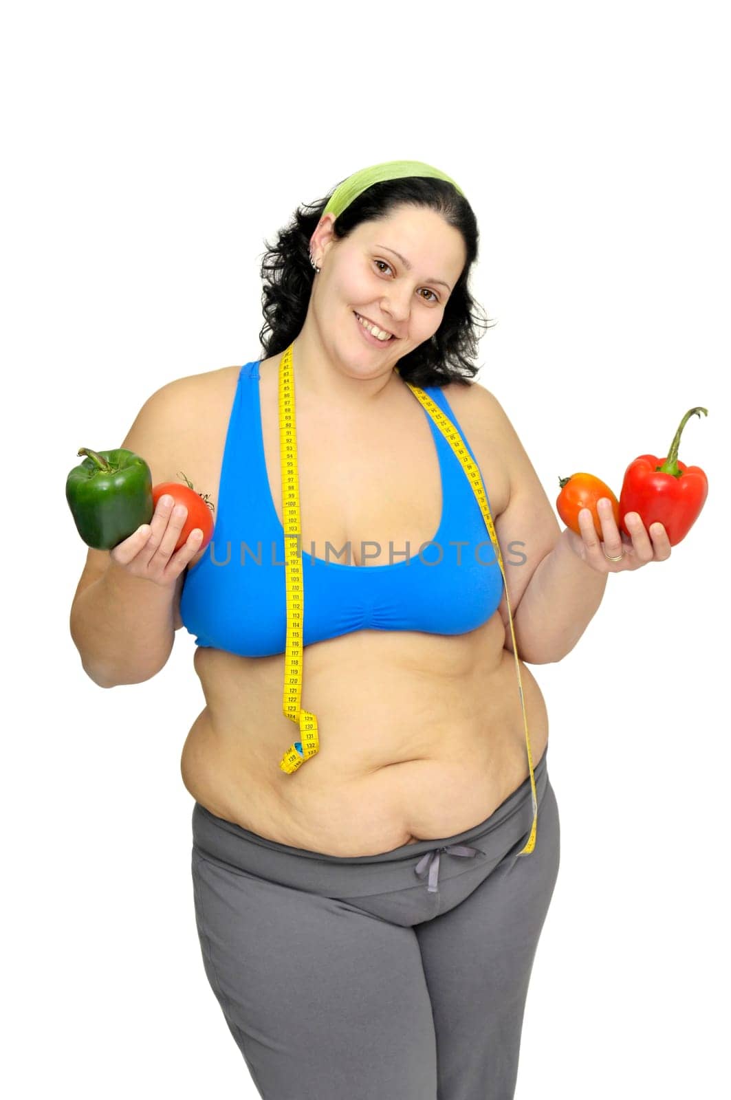 Large girl with vegetables isolated in white