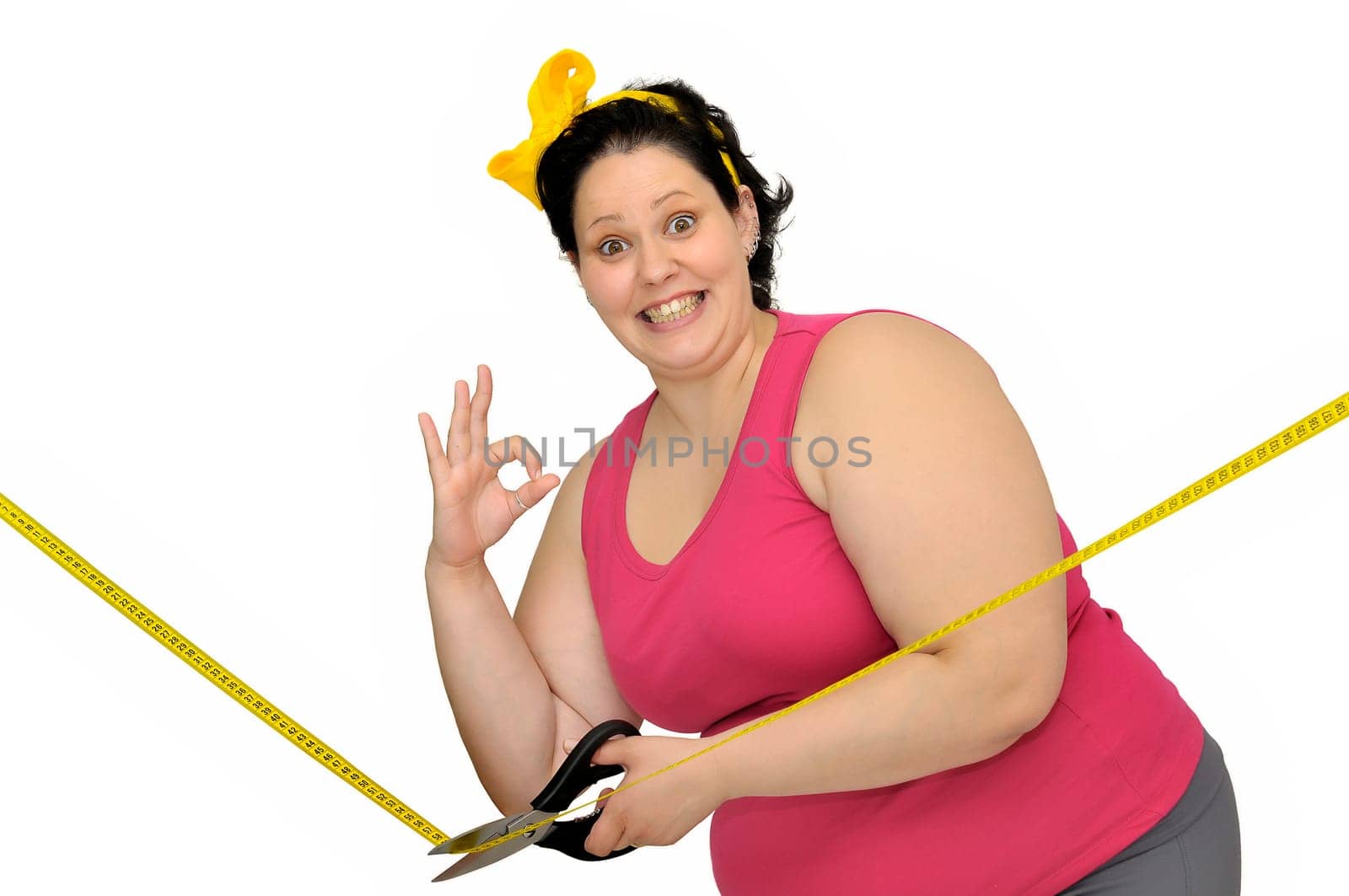 Large girl isolated in white with scissors and yellow tape