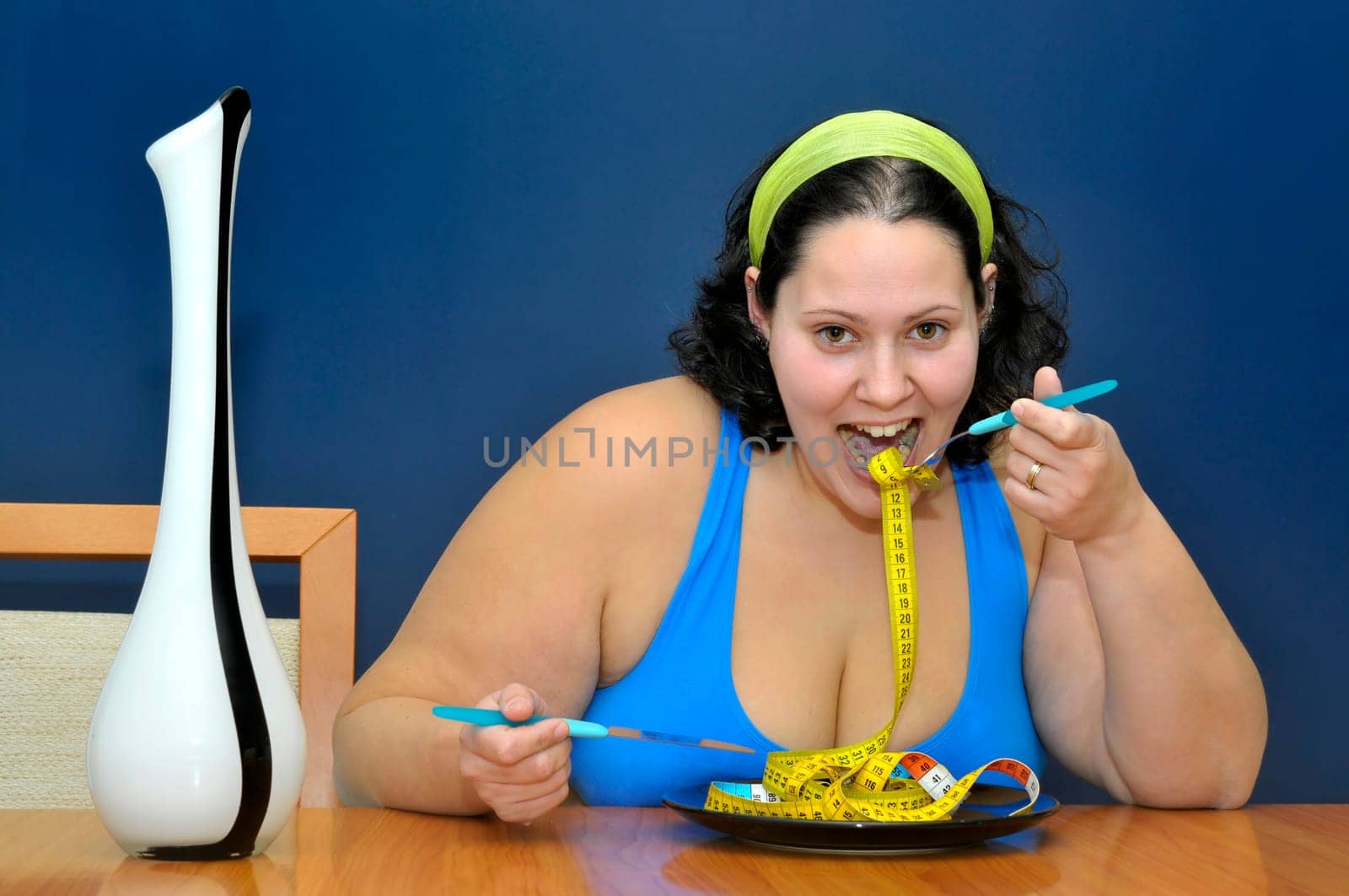 Large girl eating a measuring tape