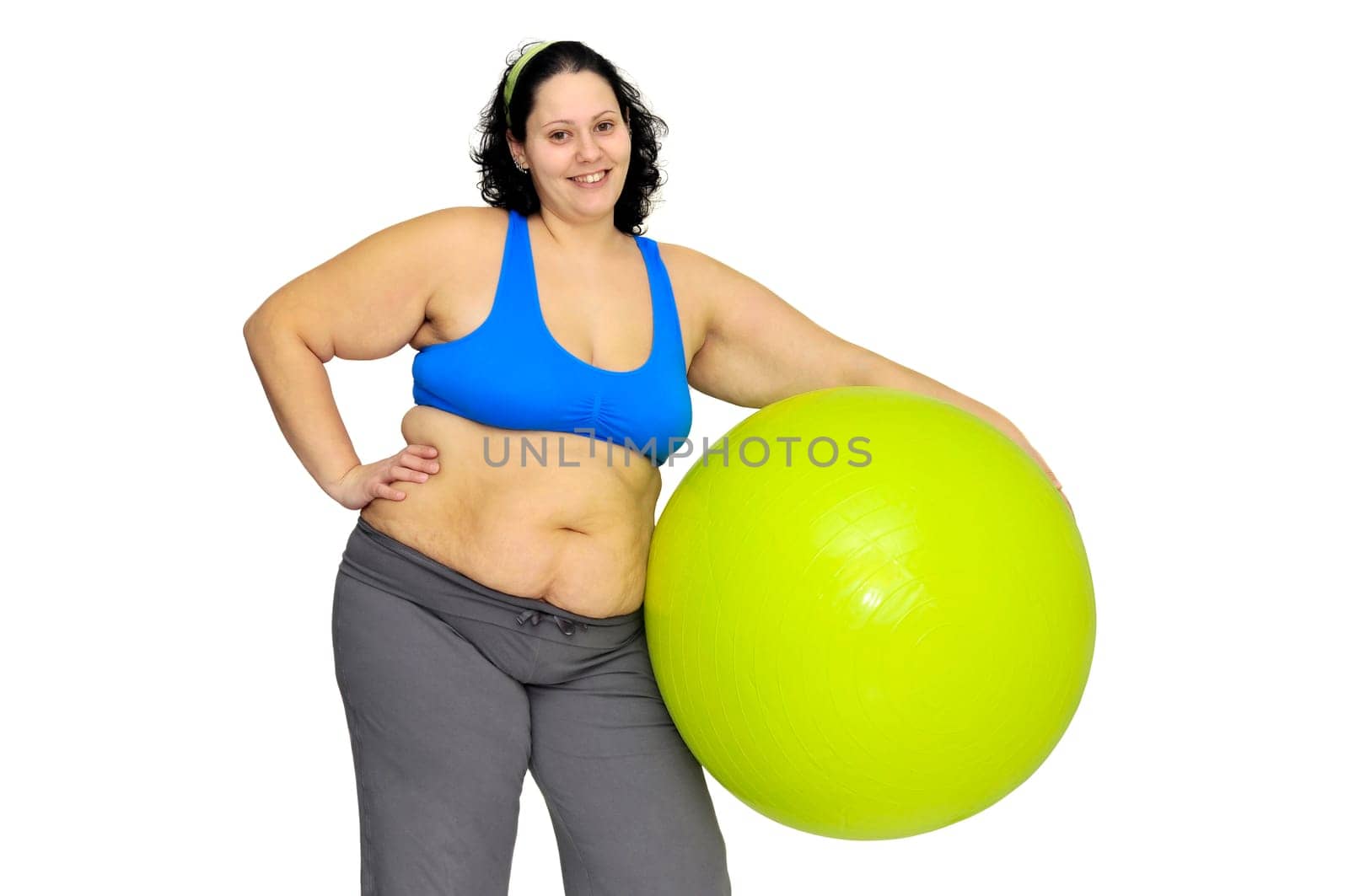 Large girl exercising with big fitness ball isolated in white