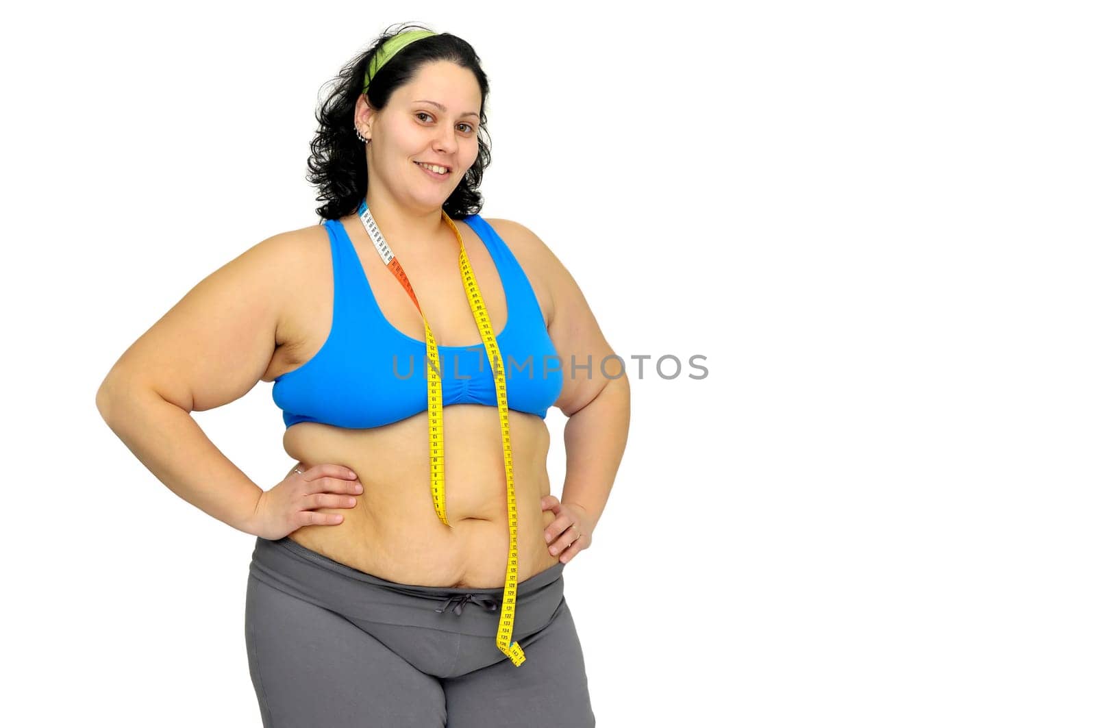 Large girl with measuring tape isolated in white