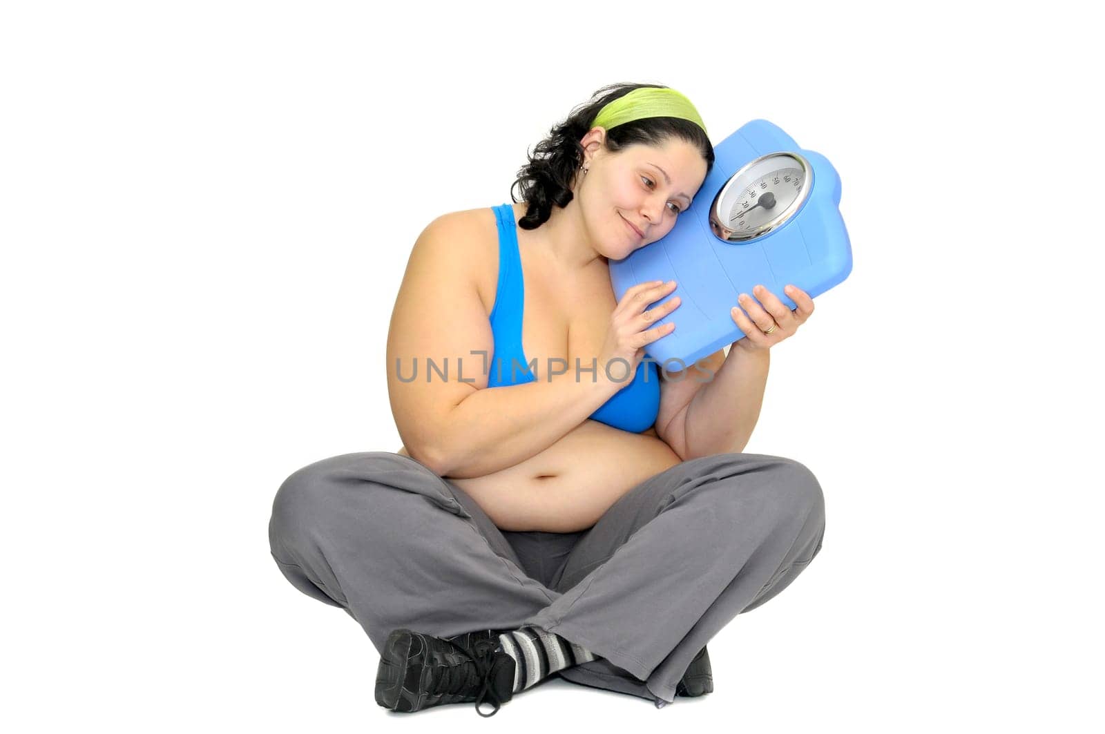 Large girl with weight scale isolated in white