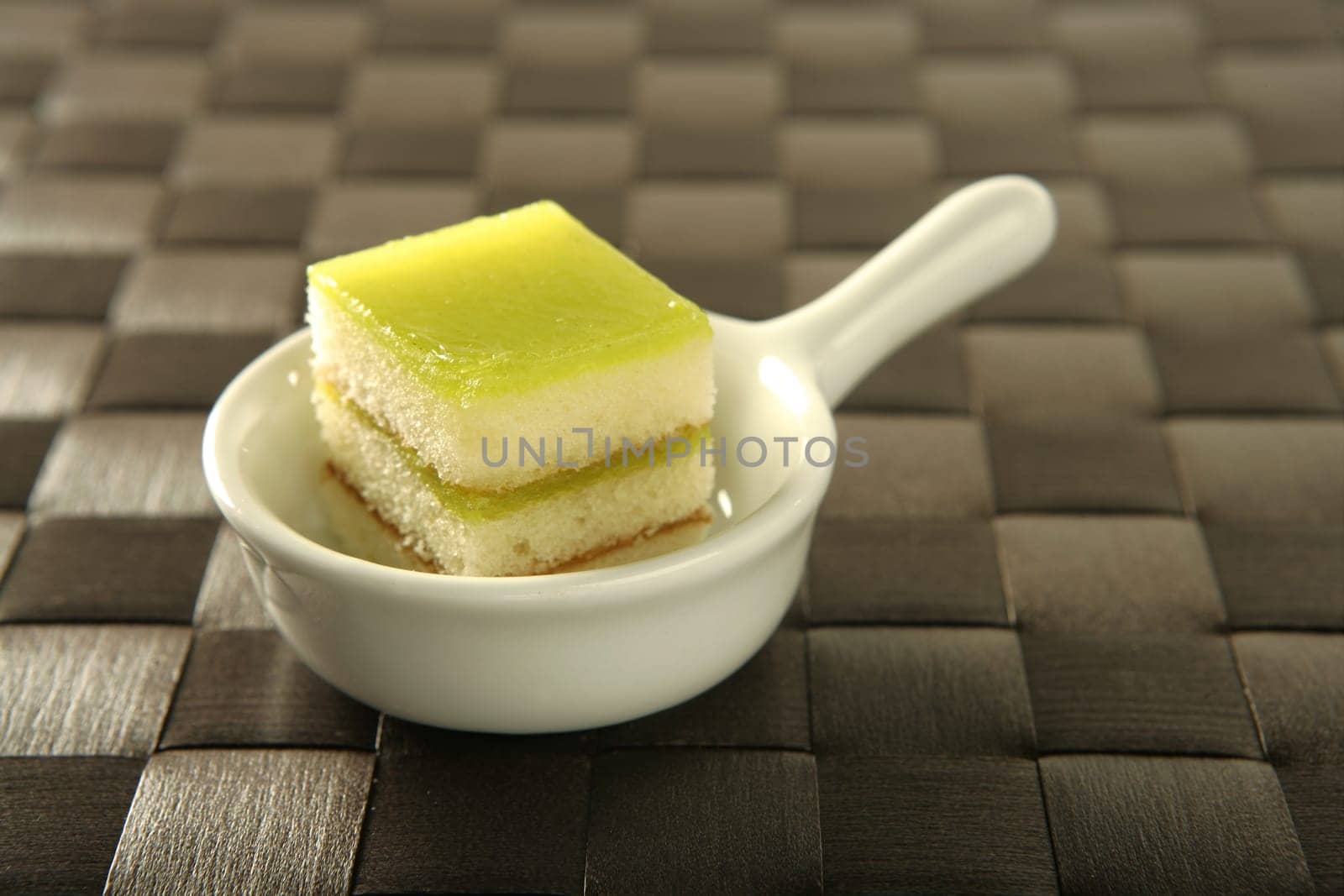 Varied pastries over spoon. Little colorful cakes
